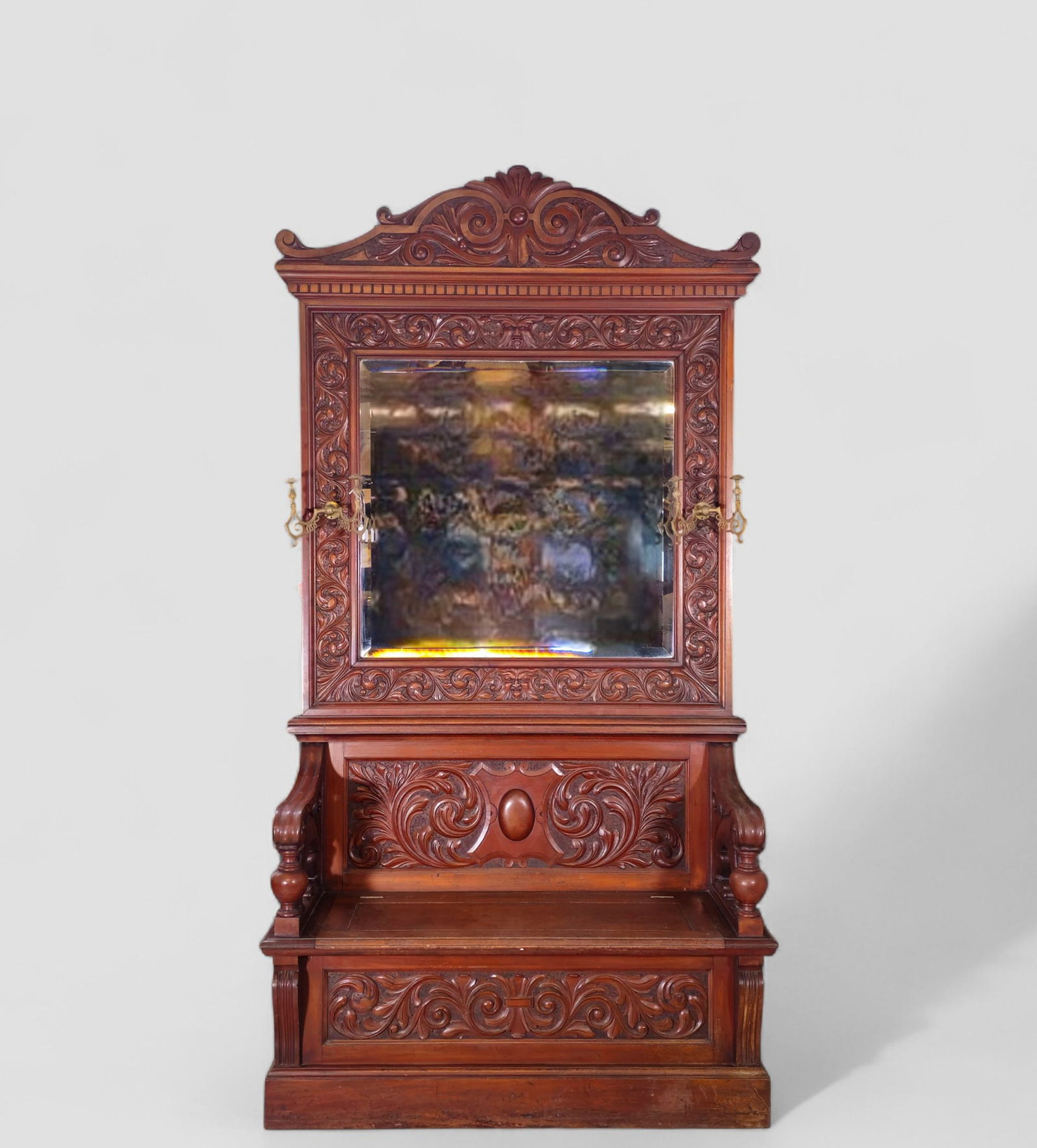 RJ Horner Attribution Carved Mahogany Man in the Mountain Hall Bench: RJ Horner Attribution Carved Mahogany Man in the Mountain Hall Bench. Circa 1880. 2 parts with original beveled mirror and brass hooks. Outstanding carved crest and frame. High relief carved scrolls