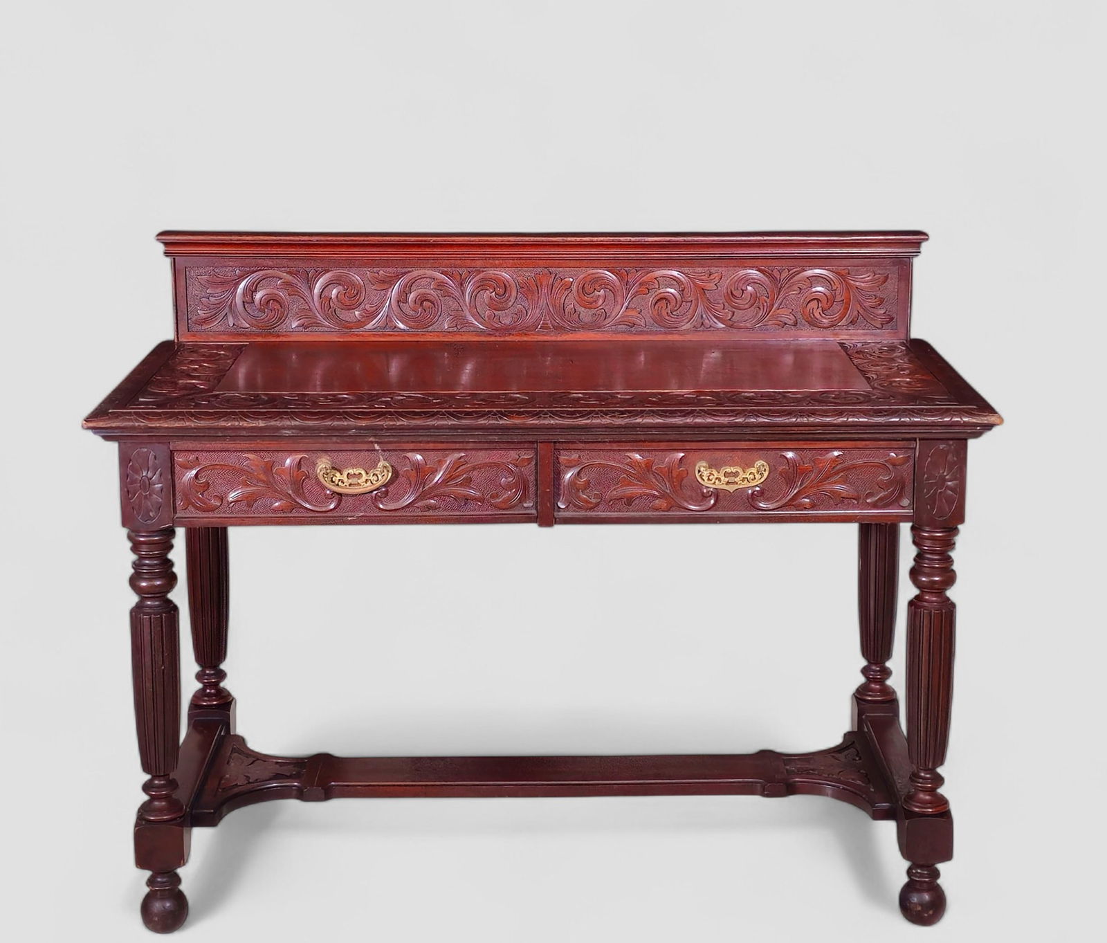 RJ Horner (Attribution) Carved Oak Library Table: RJ Horner (Attribution) Carved Oak Library Table. Circa 1890. Thumb molded top over an carved scrolled acanthus leaf back splash. Incised thumb molded border with matching carved border to top. Two