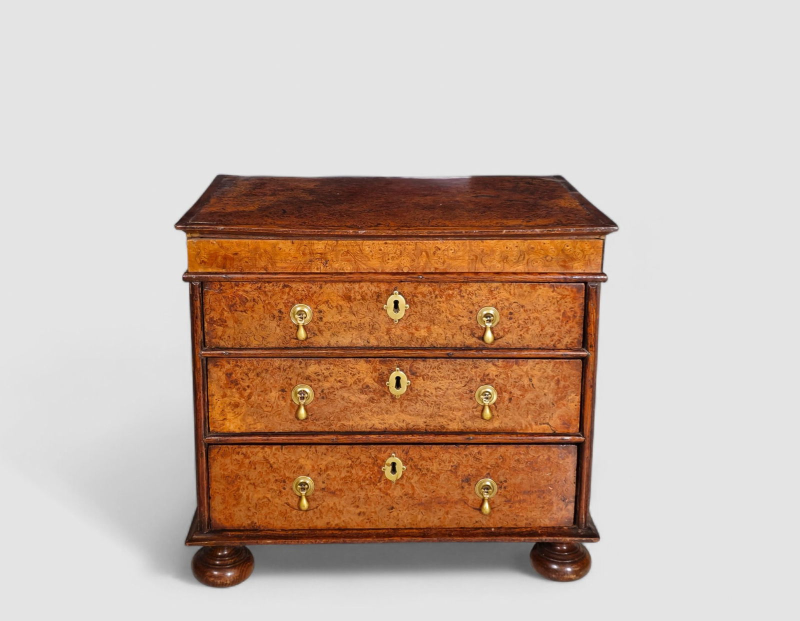 18th Century Georgian Burl Walnut Miniature Chest With Secret Drawer: 18th Century Georgian Burl Walnut Miniature Chest With Secret Drawer. Circa 1740-1760. Burl walnut to with molded border over an secret drawer. There is an lever inside of drawer. 3 graduated drawers