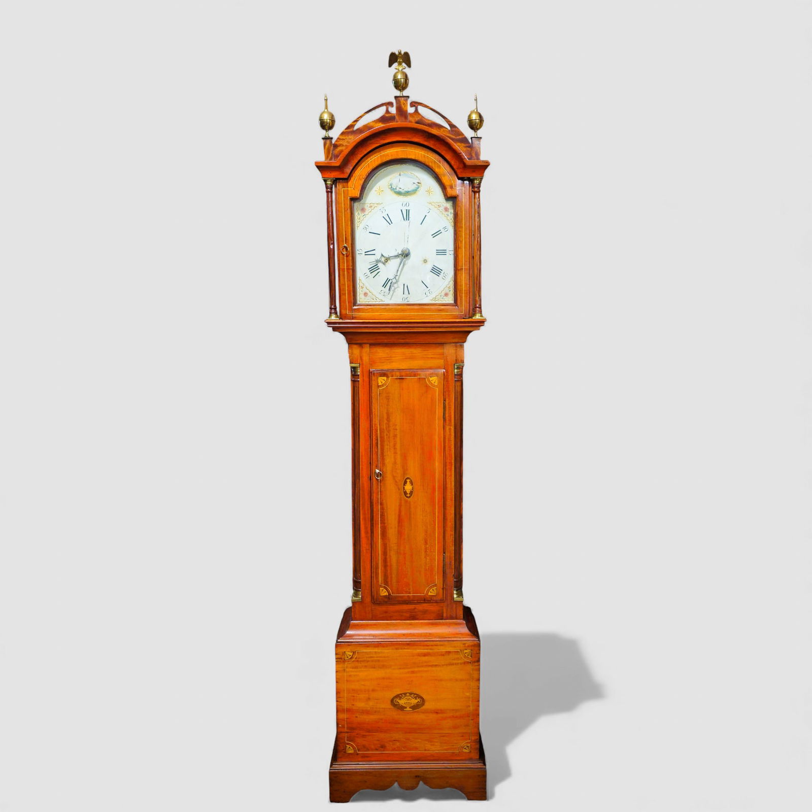 New England Cherry Inlay Tall Case Clock: New England Cherry Inlay Tall Case Clock. Circa 1800. Arched open work crown with eagle center finial flanked by two turned brass finials. Outstanding hand painted folk art face with country scene, fl