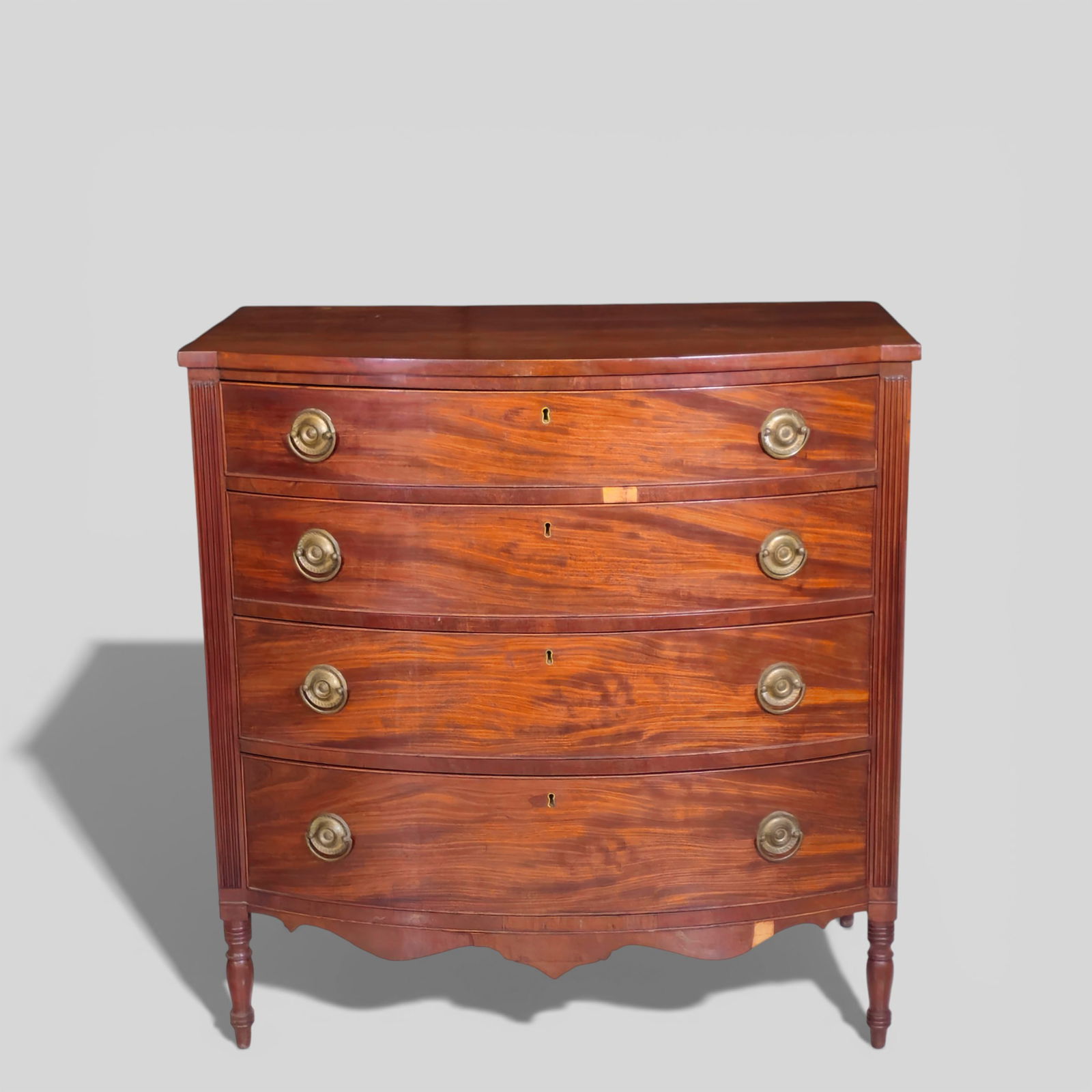 19th Century Kentucky Bow Front Chest Attributed to Robert Wilson: 19th Century Kentucky Bow Front Chest Attributed to Robert Wilson. Circa 1810-1820. Sheraton form. Bow front with 4 graduated drawers flanked by fluted fronts. Original brasses. Paneled sides,