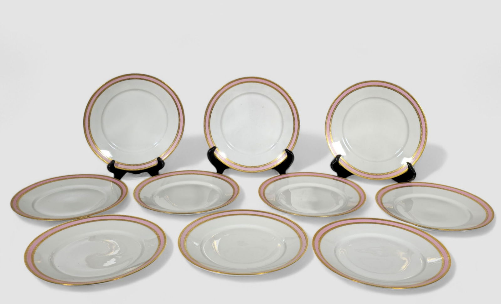 Limoges Pink and Gold Gilt Encrusted Border Porcelain Plates: Limoges Pink and Gold Gilt Encrusted Border Porcelain Plates. Set of 10. Limoges, France. Circa 1920. Manufacturer's marks to underside. 9 5/8 dia.