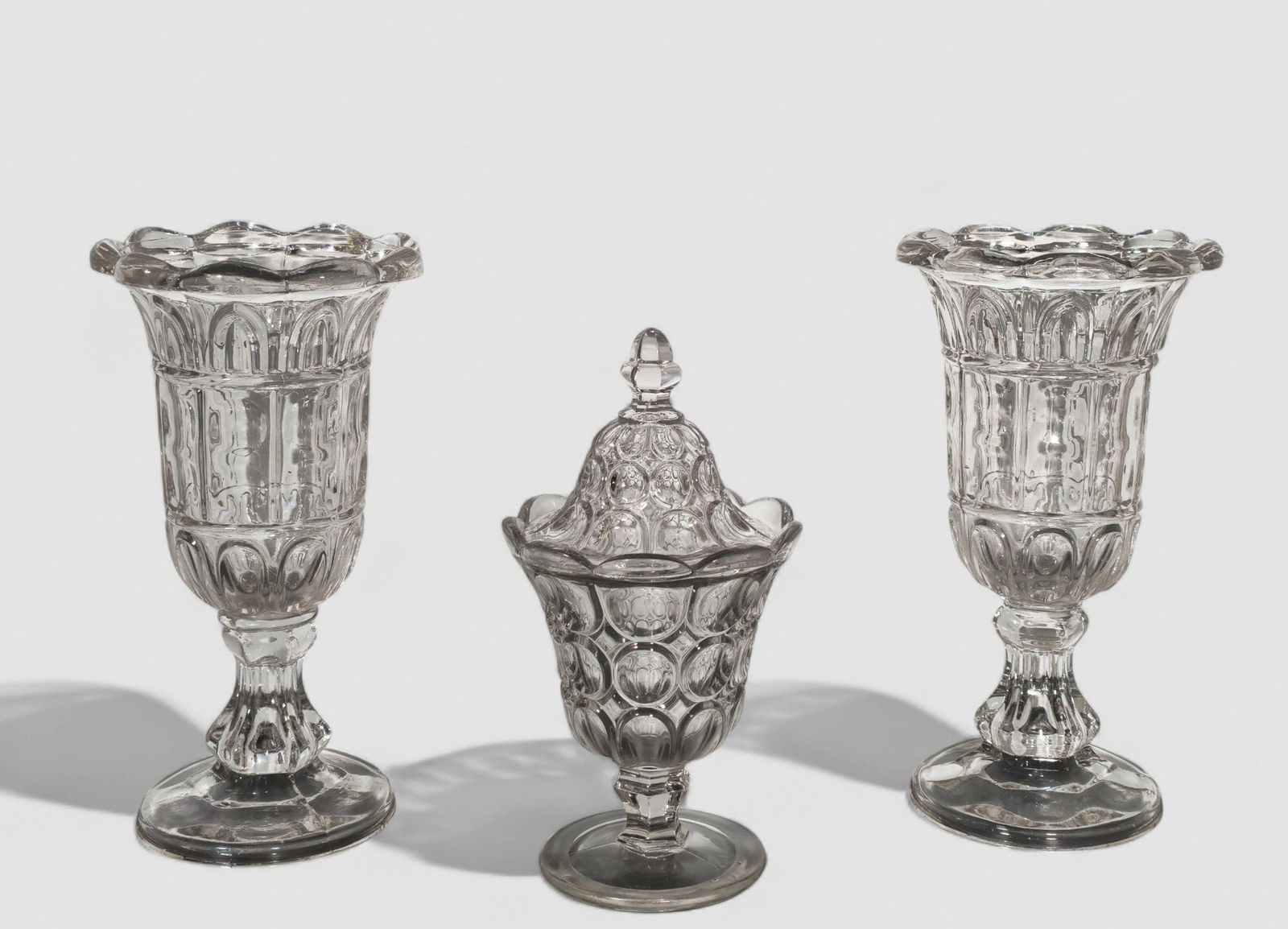 19th Century Flint Glass Celery Holders & Moon Pattern Glass Compote: 19th Century Flint Glass Celery Holders & Moon Pattern Glass Compote. Pair of celery holders, circa 1860. Gothic arch pattern. 10h. Moon pattern glass compote/covered sugar. Circa 1840. 8 3/4h.