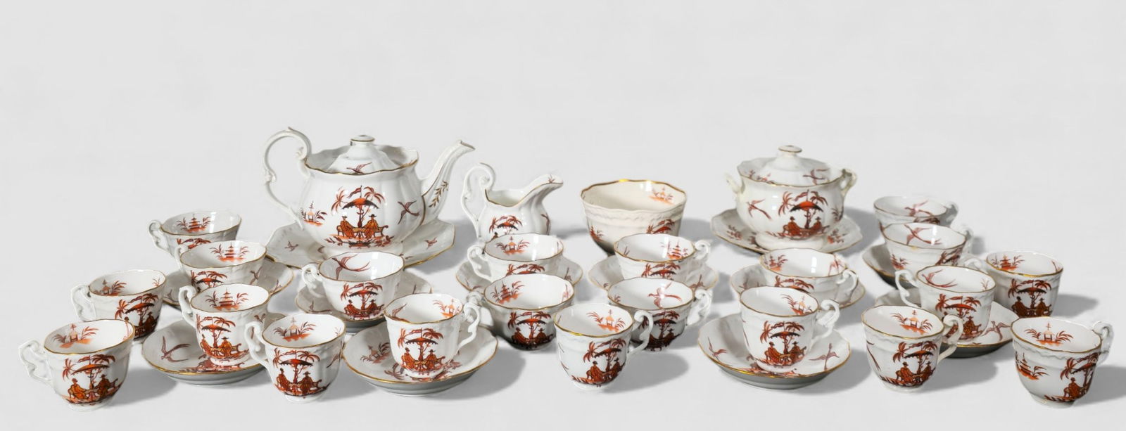 19th Century Ironstone "Chinoiserie" Porcelain Tableware: 19th Century Ironstone "Chinoiserie" Porcelain Tableware. Circa 1880. 37 pieces. Scalloped and gilt borders. Luncheon plate, bread and butter plate, 11 cups, 10 burger cups, 10 salad bowls, teapot,