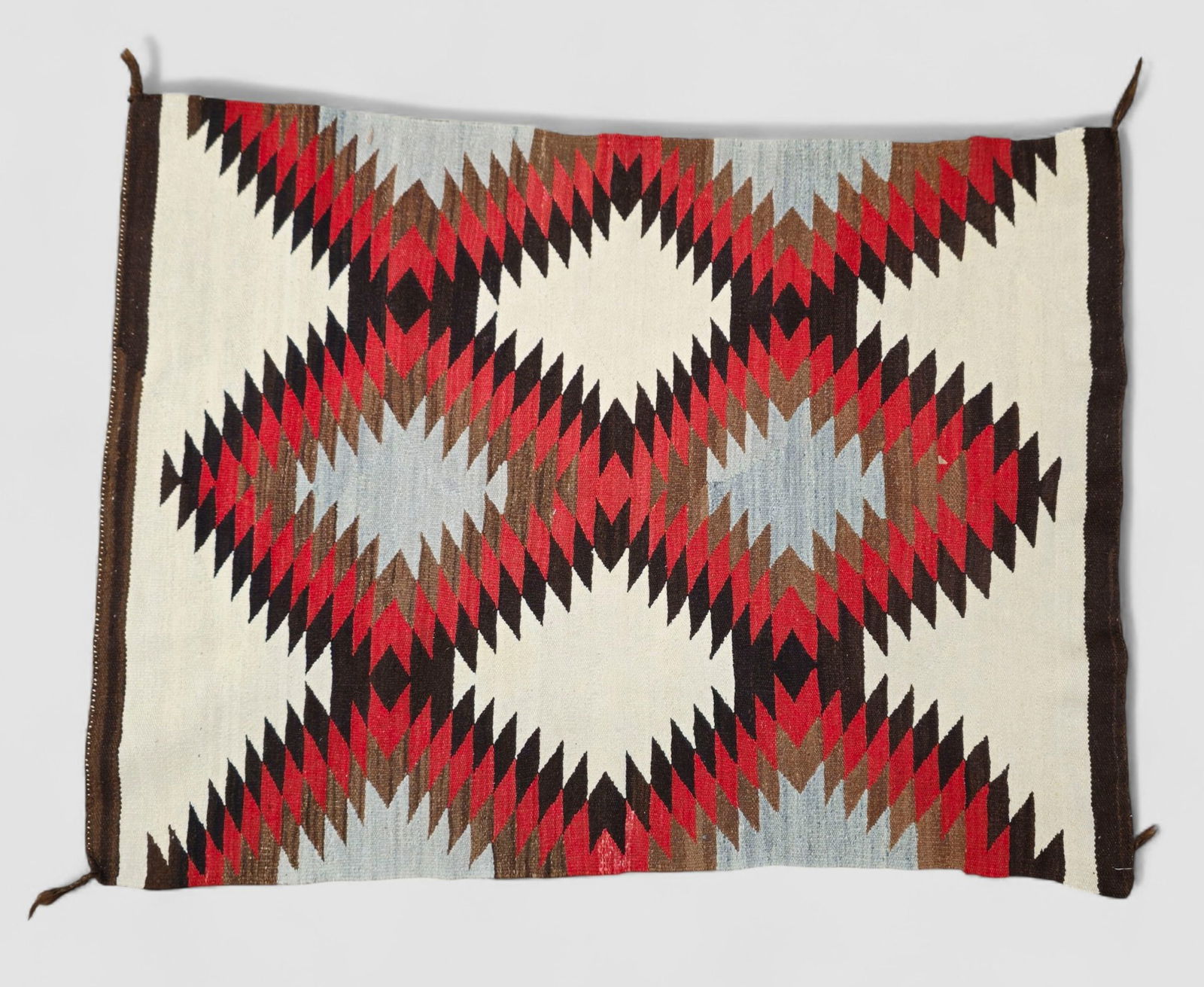 Navajo Eye Dazzle Area Rug: Navajo Eye Dazzle Area Rug, Circa 1930s. Wool on wool. 3 ft 3 1/2 in x 4 ft 6 1/4 in .