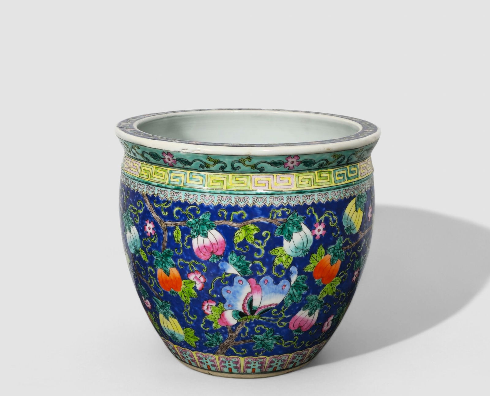 Chinese Qing Dynasty Porcelain Jardiniere: Chinese Qing Dynasty Porcelain Jardiniere. Blue ground decorated with butterflies and fruit. 12d x 11h.