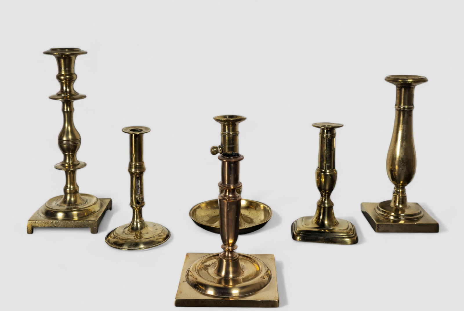 Assembled 18th Century and Early 19th Century Brass and Bronze Candlesticks: Assembled 18th Century and Early 19th Century Brass and Bronze Candlesticks. 6 total. 18th Century side ejector chamber stick. England. Heavy bronze candlestick with disc turnings. England. Circa