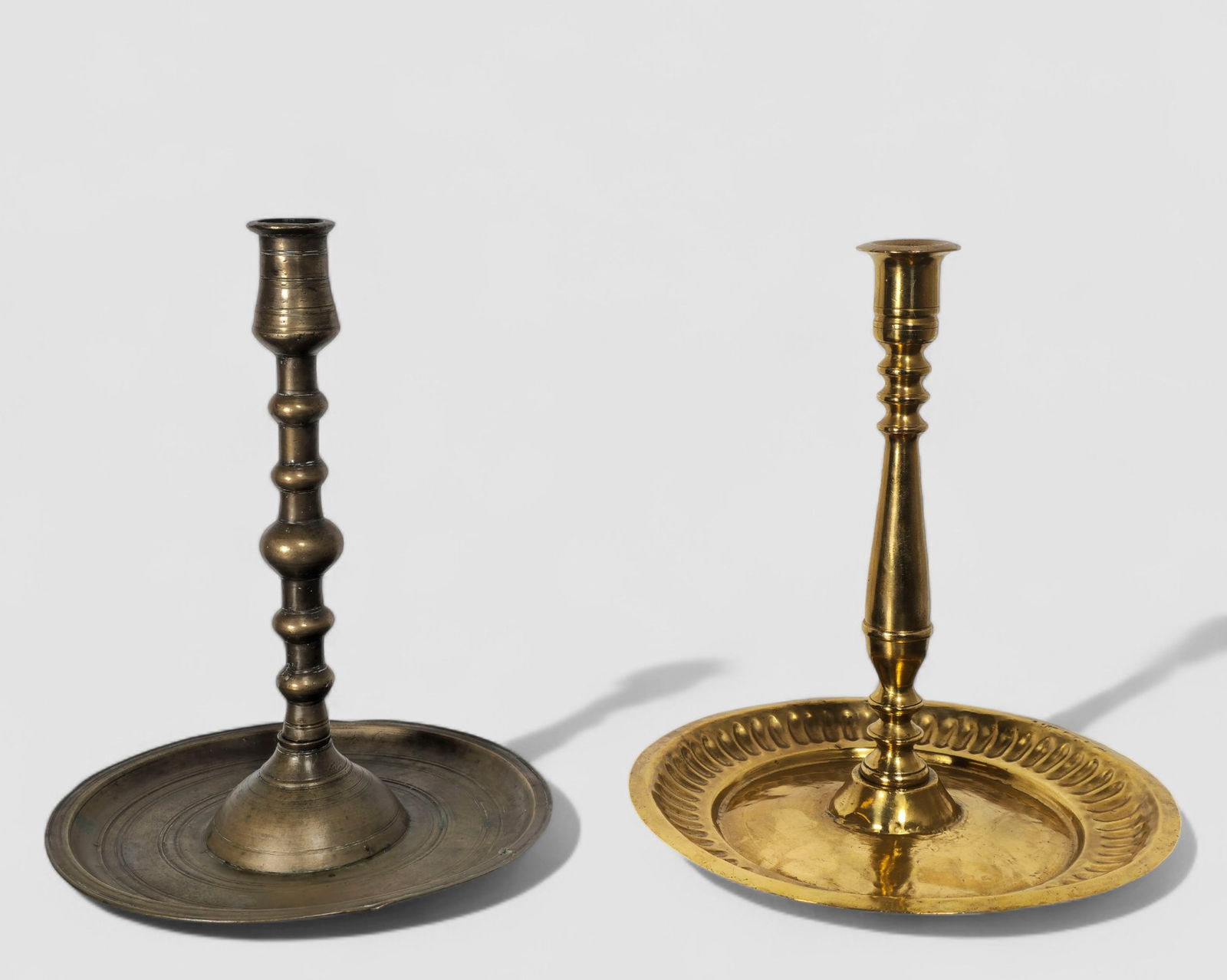 16th Century British/Flanders Brass Candlesticks: 16th Century British/Flanders Brass Candlesticks.2 candlesticks: Oxidized brass with wide drop pan. Circa 1580-1600. Dome bases and five slightly ovoid knobs and flared socket. 9 1/2 diameter X 11