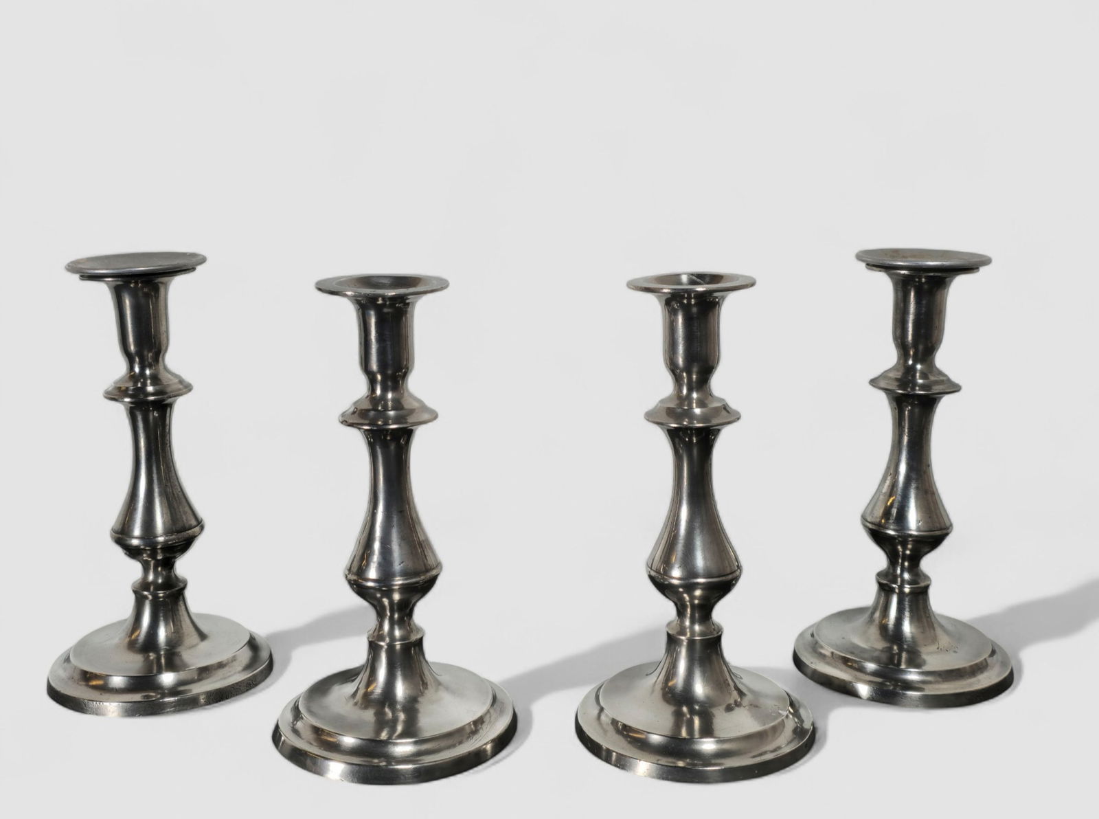 19th Century Homan Cincinnati Pewter Candlesticks: 19th Century Homan Cincinnati Pewter Candlesticks. Set of 4. Circa 1850. 4 1/4 dia x 7 7/8 h.