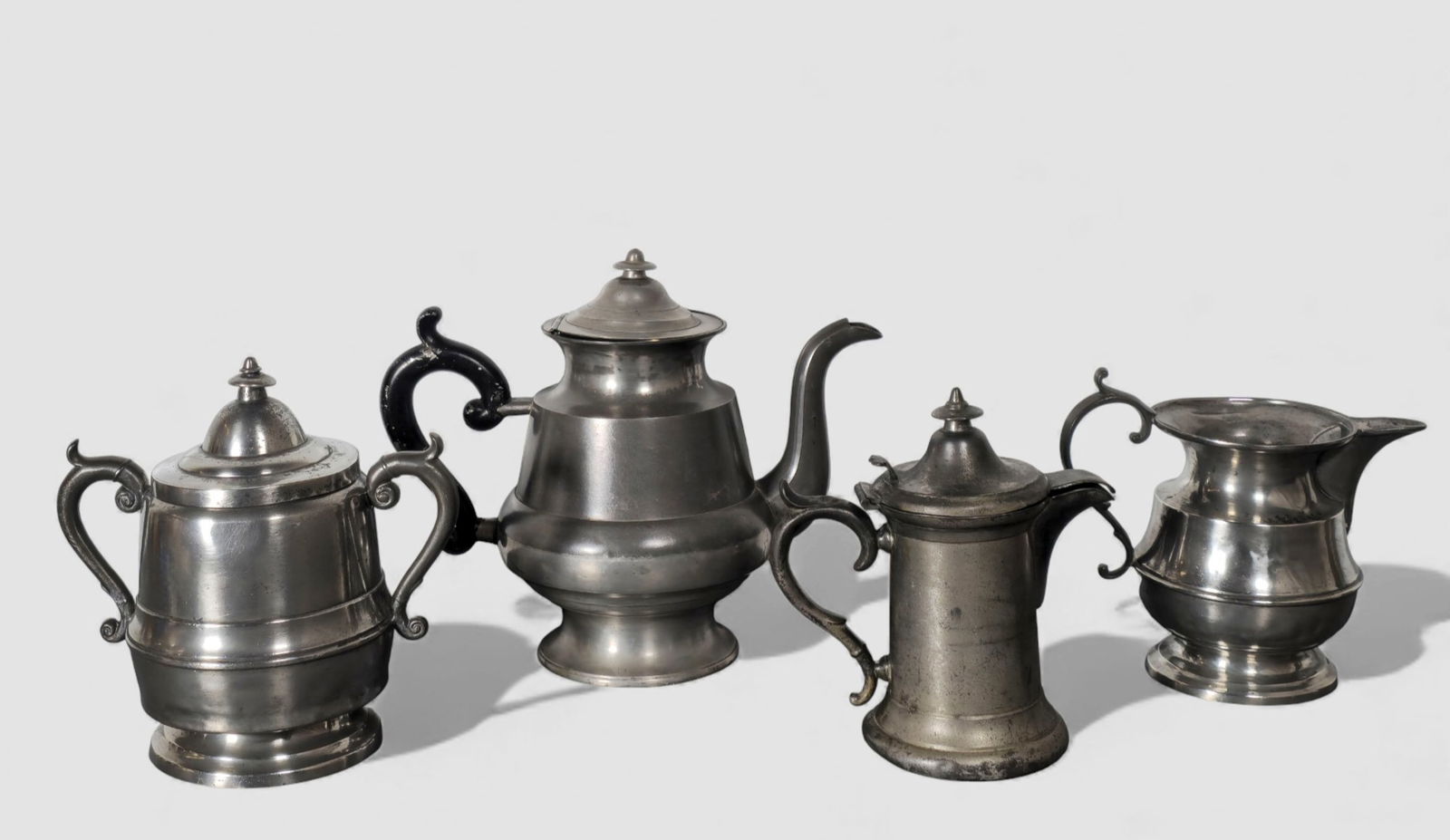 Assemble 19th Century American Pewter: Assemble 19th Century American Pewter. 4 total pieces. H. Holman syrup pitcher 2 dia x 6 h. Cream pitcher, circa 1840-1850. 4 5/8 h. Teapot with original painted handle. Circa 1840-1850. Barnstable,