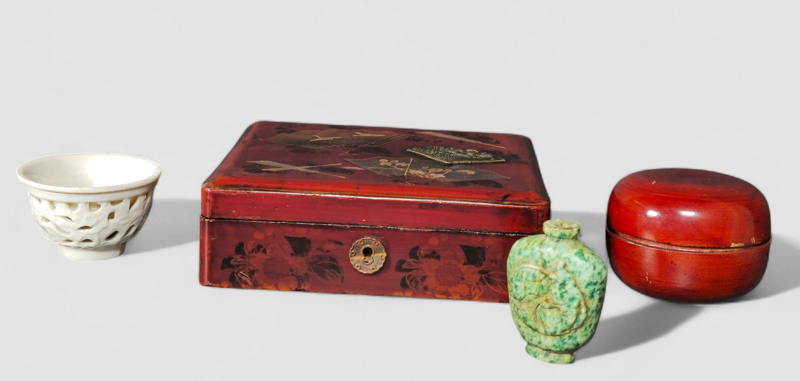 Assembled Chinese & Japanese Assortment: Assembled Chinese & Japanese Assortment. 4 pieces total. Red Lacquer box decorated with an fan. Japan. Early 20th century. 6 7/8w x 6d x 2 1/4h. Red lacquered box. Japan Mid 20th Century. 3dia x 2