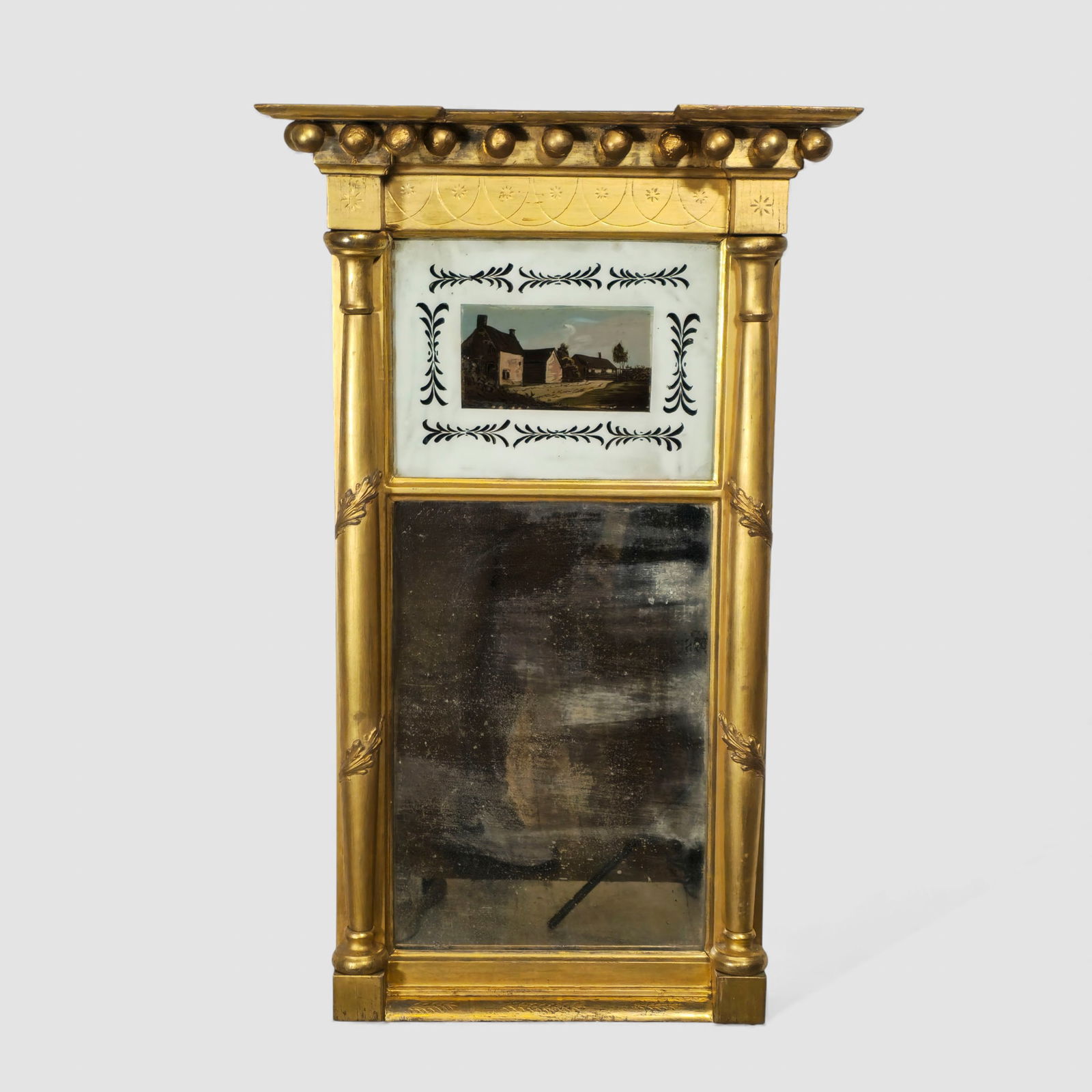 19th Century Giltwood Reverse Painted New England Mirror: 19th Century Giltwood Reverse Painted New England Mirror. Circa 1820-1830. American Sheraton giltwood mirror. Teardrop sphere pendants. Reverse painted glass of New England country road. Flanked by