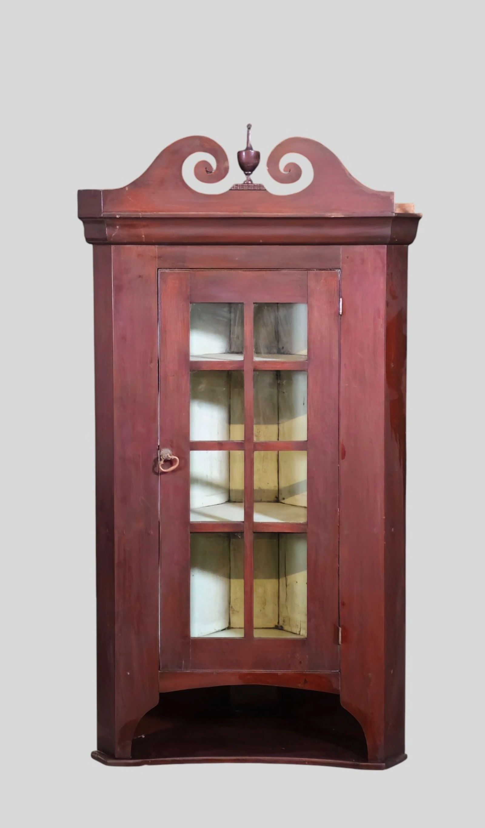 19th Century Boston Hanging Corner Cupboard: 19th Century Boston Hanging Corner Cupboard. Circa 1780. Mahogany broken arch crown with turned urn finial. Crown rests on cove molded top over an 8 pane glass door. Robin egg blue interior. Paneled