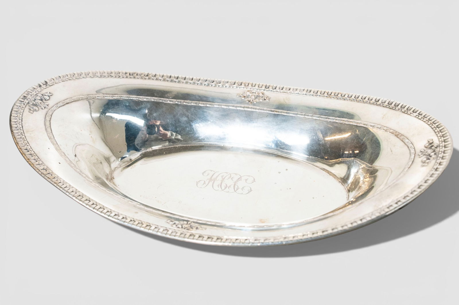 Windsor Sterling Silver Oblong Serving Bowl, #A84-60: Windsor Sterling Silver Oblong Serving Bowl, #A84-60. Gadroon & Beaded borders. Embossed flowers and ribbons. Manufacturer's mark to underside. Sterling and #A84-60. 12 7/16w x 7d x 23 7/8h. Weight- 1