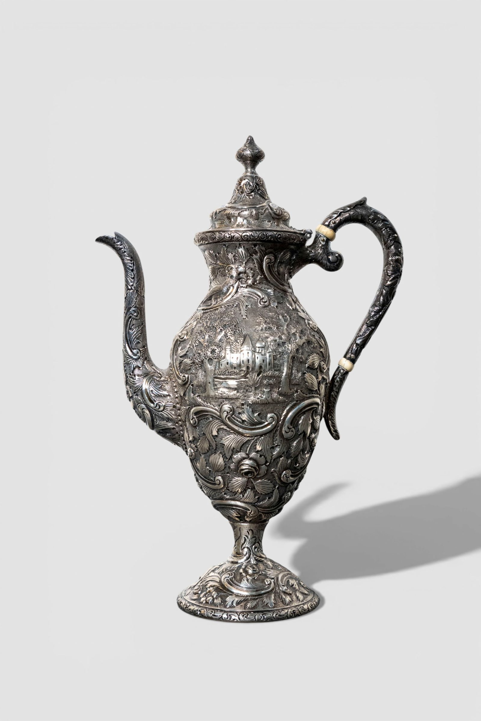 Loring Andrews Sterling Silver "Castle" Pattern Tea Pot, #207: Loring Andrews "Castle" Pattern Tea Pot, #207. Hinged lid. Repousse design with high relief castle, flowers, scrolls and landscapes. Manufacturers marks to underside. Sterling: #207. 7w x 3 1/2d x 11