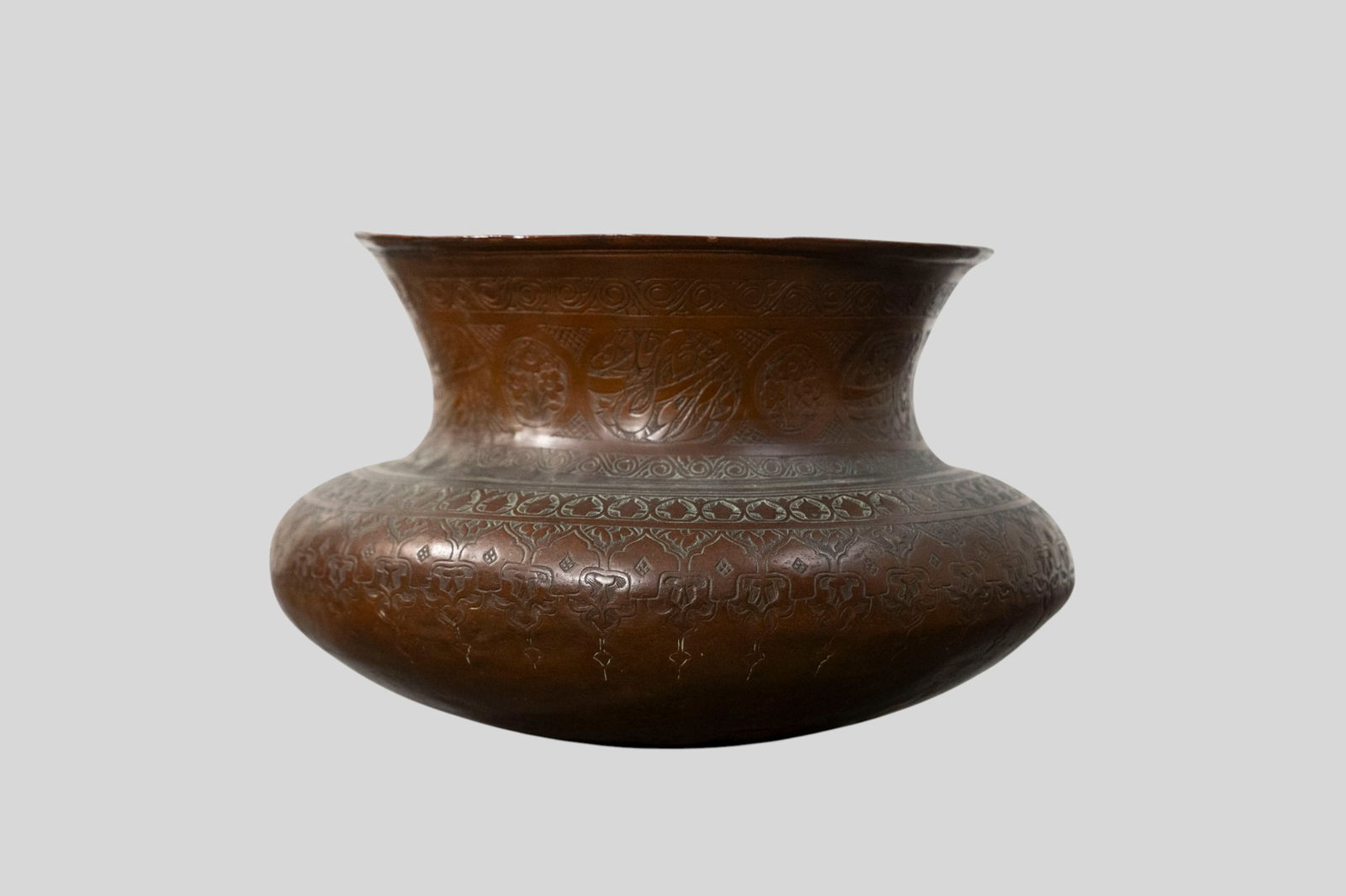 18th Century Persian Engraved Copper Bowl: 18th Century Persian Engraved Copper Bowl. Circa 1720-1740. Flared rime over an tapered bulbous body. Engraved flowers and decoration on neck. 7 1/2 dia x 5 1/2h.