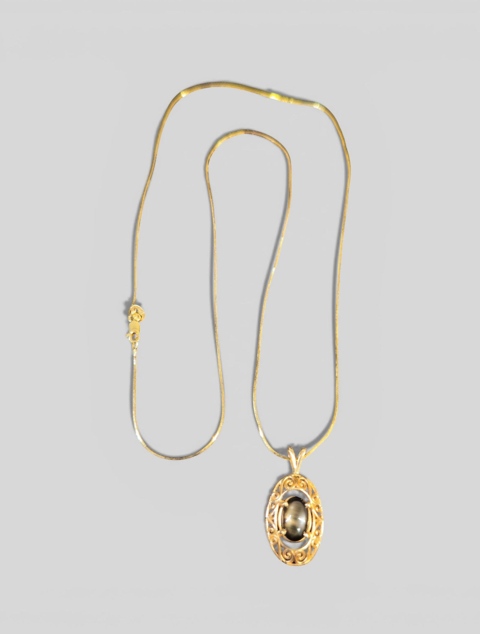 14K Gold & Cat's Eye Filagree Pendant & Chain: 14K Gold & Cat's Eye Filagree Pendant & Chain. Total drop - 10 1/2." Chain drop - 9 3/4." Pendant - 1." Total gross weight - 4.5g.