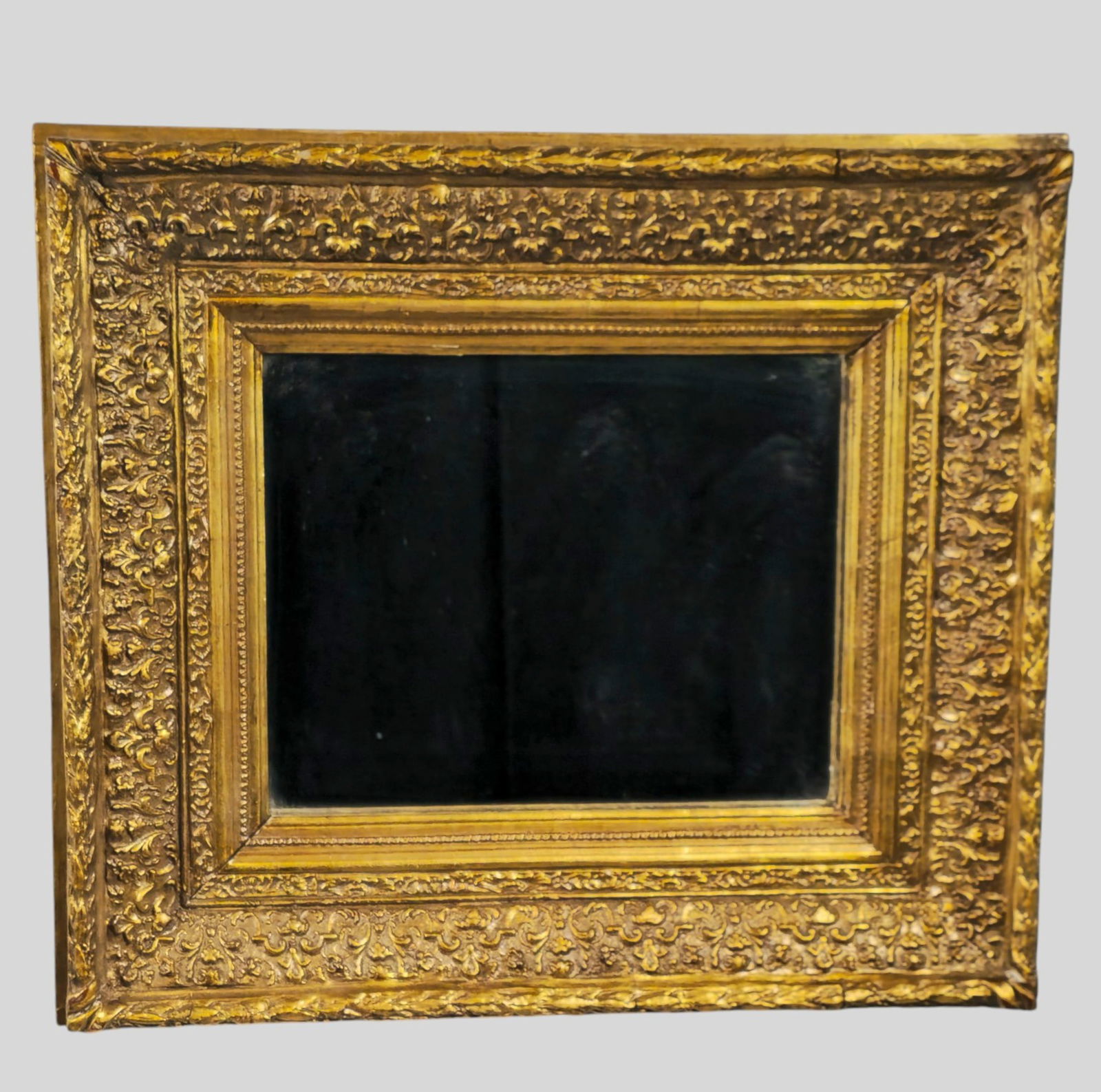 1920s Carved Gilt Gesso Mirror: 1920s Carved Gilt Gesso Mirror. Molded exterior carved interior. 21 3/4w x 2 3/4d x 19 1/8h.