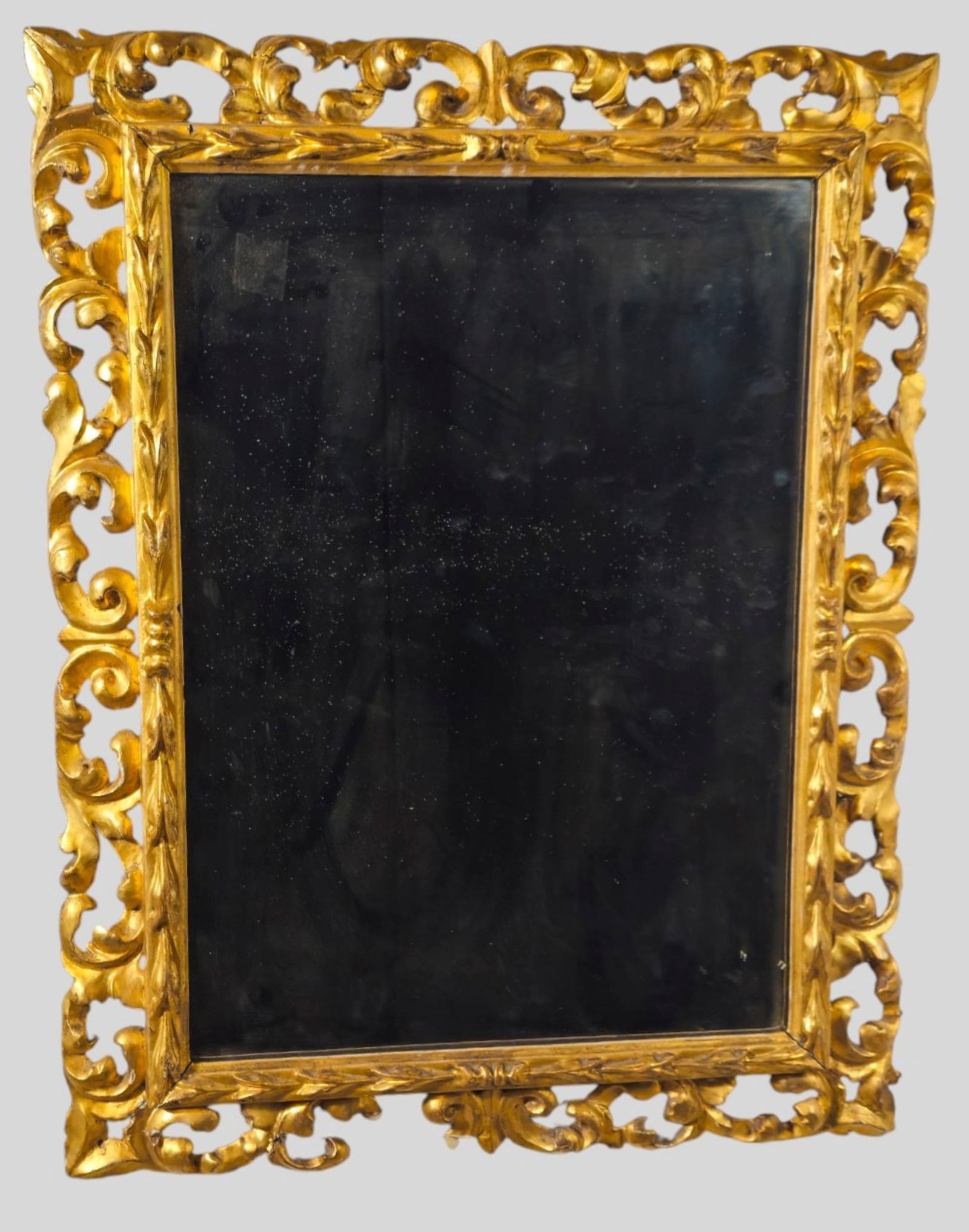 1920s Carved Openwork Giltwood Mirror: 1920s Carved Openwork Giltwood Mirror. High relief carved scrolled acanthus leaves. 25 1/2w x 2d x 32 1/2h.