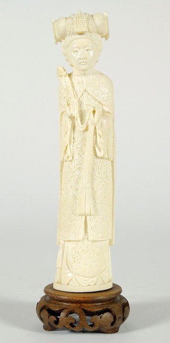 Chinese Carved Ivory Figure: Hand carved figure of young noblewoman in elaborate robe holding a snake. 8.75. This lot can not be shipped internationally.
