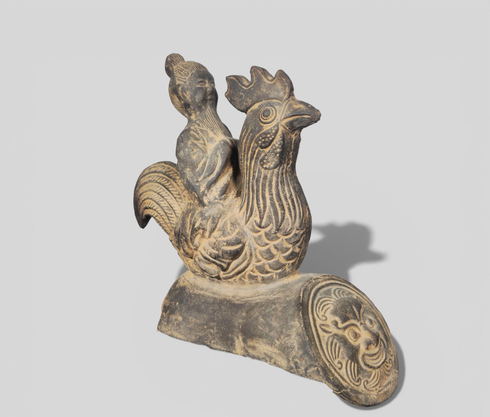 Chinese Qing Period Taoist Immortal Roof Tile Figure: Chinese Qing Period Taoist Immortal Roof Tile Figure. An unglazed terracotta roof‑tile figure dating to the Qing period, depicting a Taoist immortal riding a rooster—an auspicious symbol
