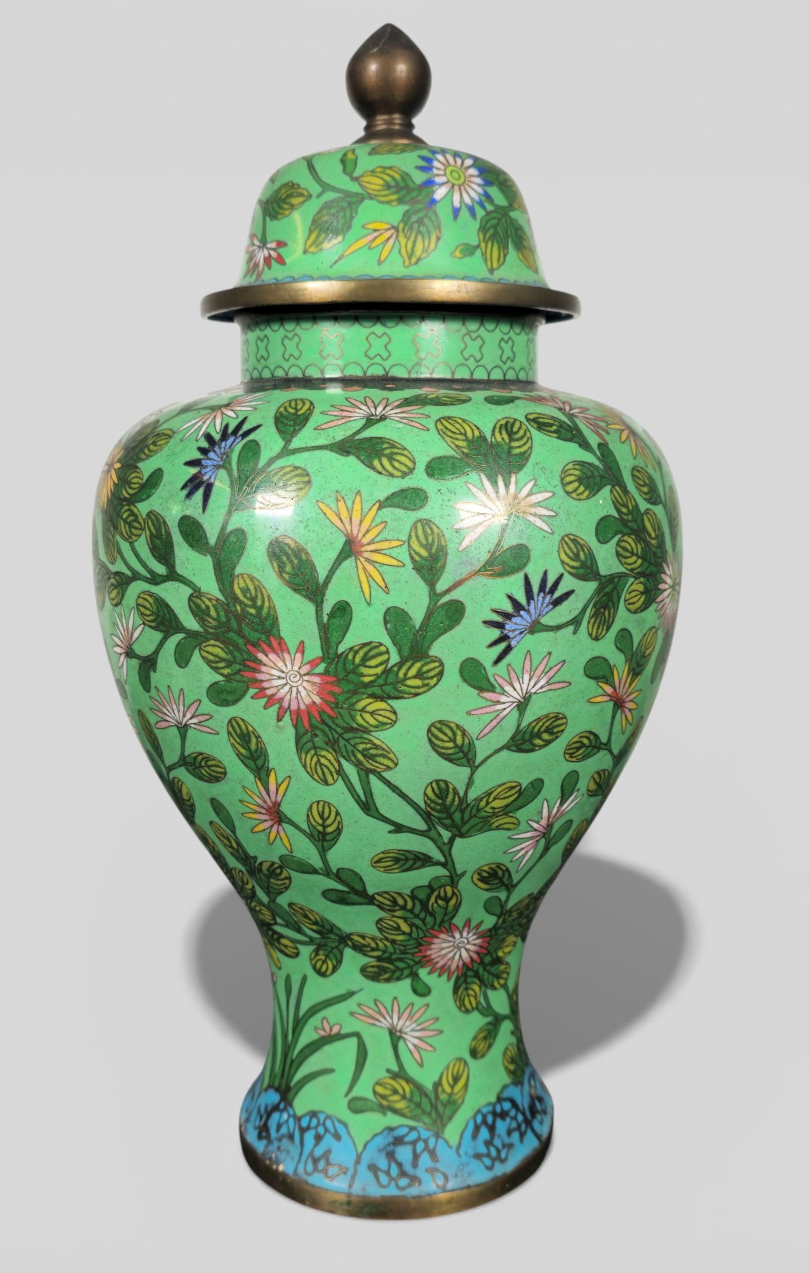 Chinese Cloisonné Enamel Temple Jar, Green Ground, 19th Century: Chinese Cloisonné Enamel Temple Jar, Green Ground, 19th Century. Finely enameled cloisonné temple jar, the ovoid body set on a short foot and rising to a domed cover, all against a rich gree