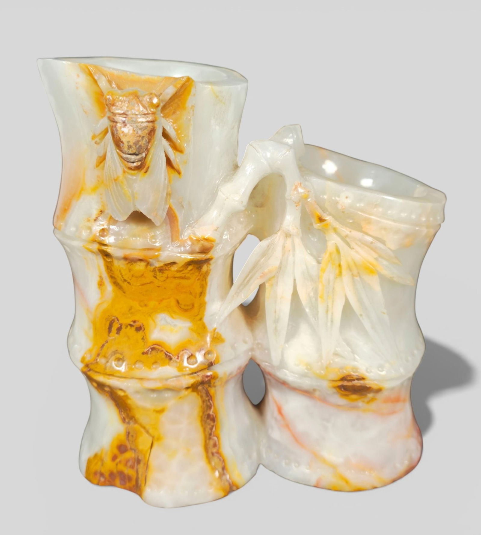 Chinese Carved Jade Double Bamboo Brush Pot with Cicada: Chinese Carved Jade Double Bamboo Brush Pot with Cicada. Chinese carved jade brush pot formed as double bamboo stalks, the surface detailed with naturalistic nodes and vertical striations. A carved ci