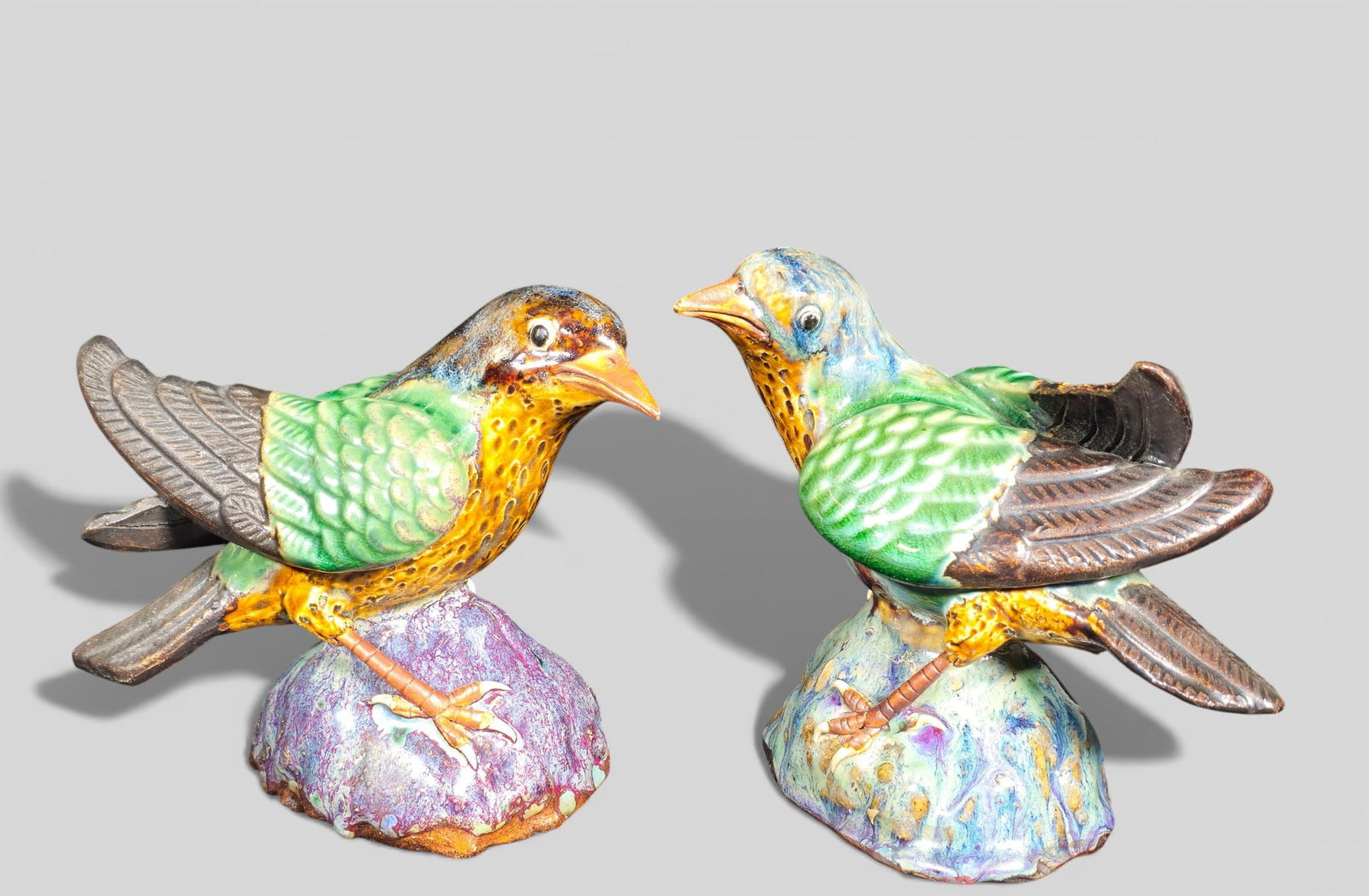 Pair of Chinese Shiwan Pottery Export Bird Figurines: Pair of Chinese Shiwan Pottery Export Bird Figurines. A pair of Chinese Shiwan pottery export bird figurines, modeled with rich, vibrant colors and green‑glazed wings. Each figure bears a maker&