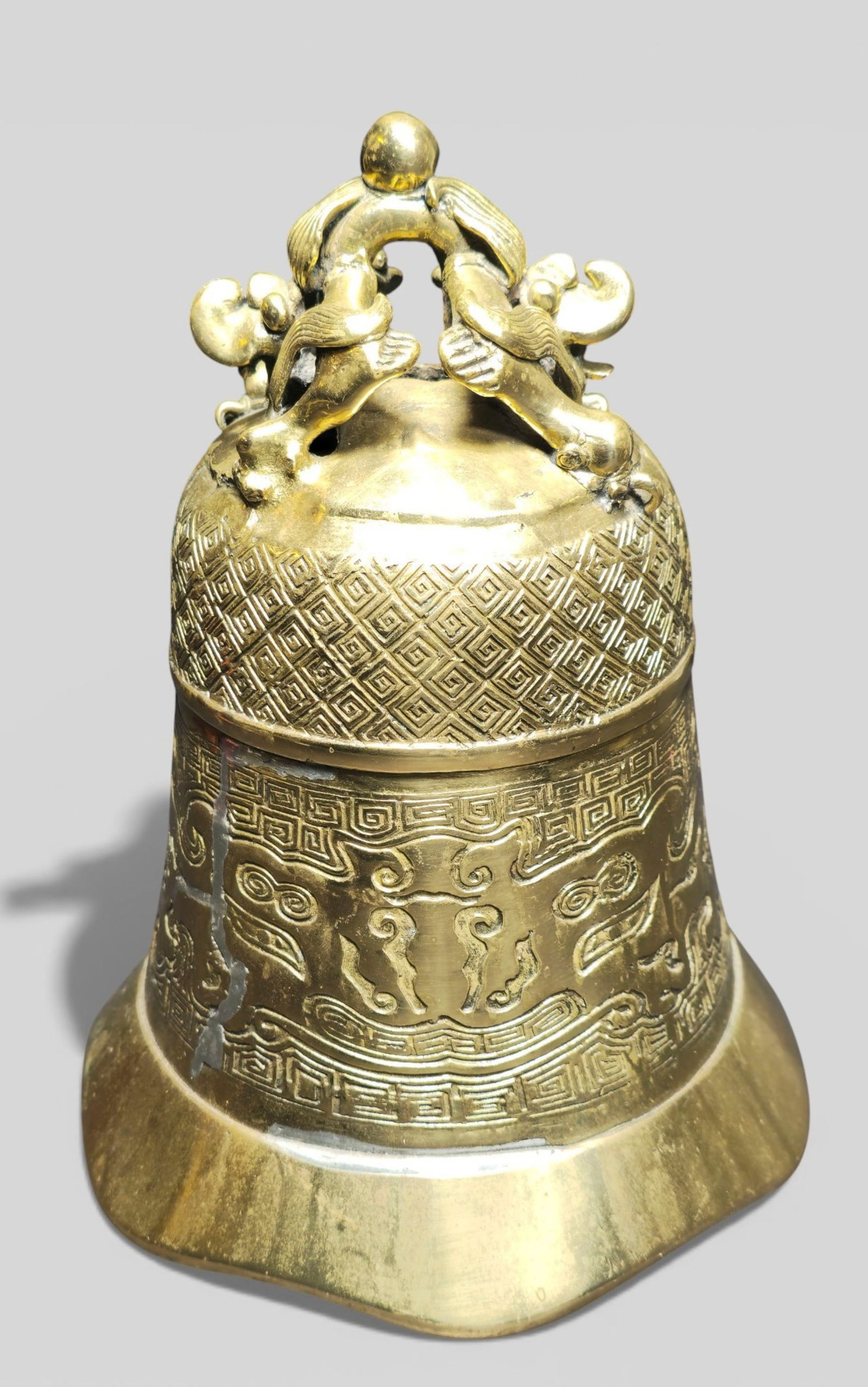 Chinese Gilt Bronze Temple Bell with Dragons: Chinese Gilt Bronze Temple Bell with Dragons. Chinese gilt bronze temple bell topped with two dragons and decorated on the body with archaic bat motifs. Traditional form with auspicious symbolism and