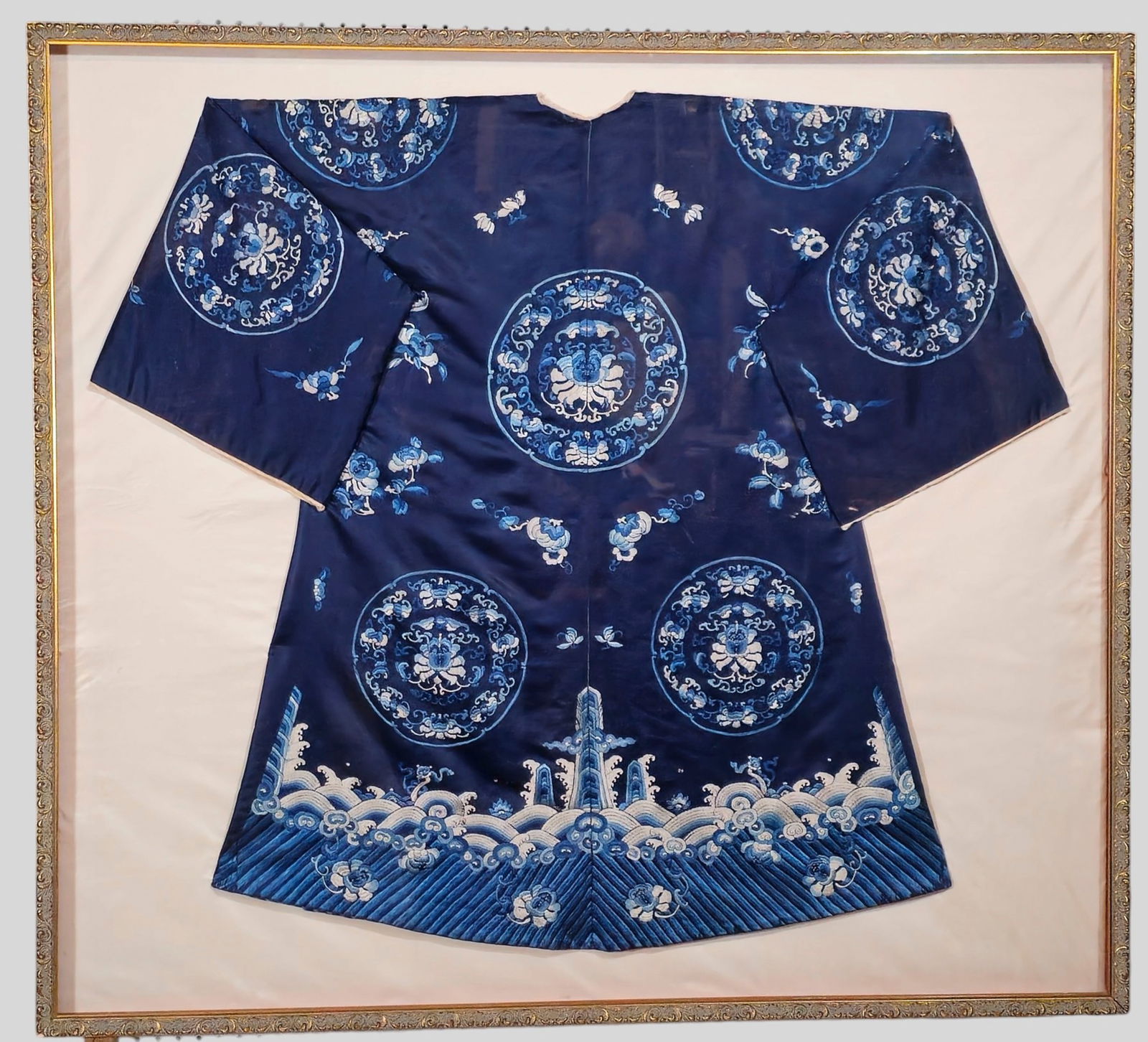 A 19th Century Qing Dynasty Silk Robe : A 19th Century Qing Dynasty Silk Robe. Circa 1860-1870 Hand embroidered silk robe with lotus medallions, flower waterways and clouds; gilt/shell frame; silk backing. Robe: 48w x 42h (approx.); Frame: