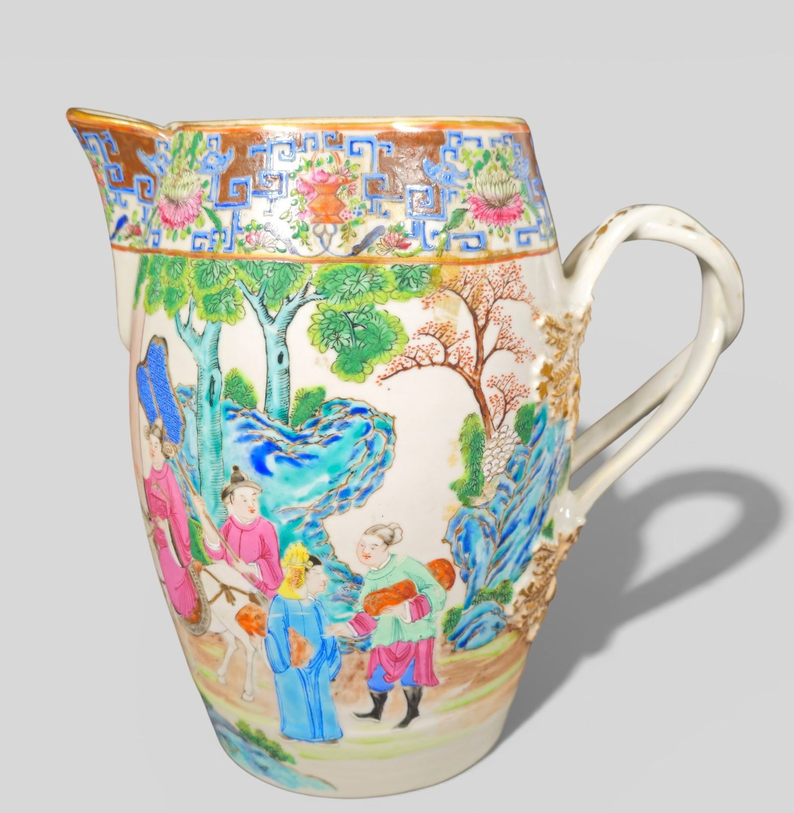 Early 19th Century Chinese Export Rose Mandarin Porcelain Cider Jug: Early 19th Century Chinese Export Rose Mandarin Porcelain Cider Jug. Circa 1800-1810. Figure over a landscape grounds to one side. Figures by window to other. Intertwining handle. 9w x 5 1/2d x 9h.