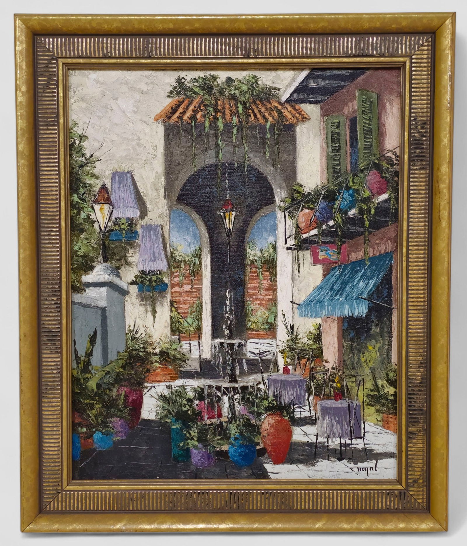 Myrl D’Arcy "Spanish Courtyard" Oil Painting: Myrl D’Arcy (Louisiana, 20th Century), oil painting depicting a colorful Spanish-style courtyard with lush potted plants, café tables draped in lavender cloths, a tiered fountain, and an
