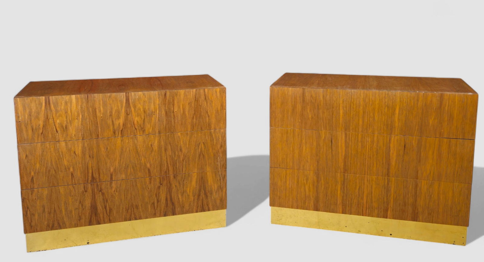 Milo Baughman Bedside Chest/ Dressers: A pair of mid-century walnut chests designed by Milo Baughman for Thayer Coggin, each featuring three full-length drawers with book matched walnut veneer fronts and recessed pulls. Both cases sit on