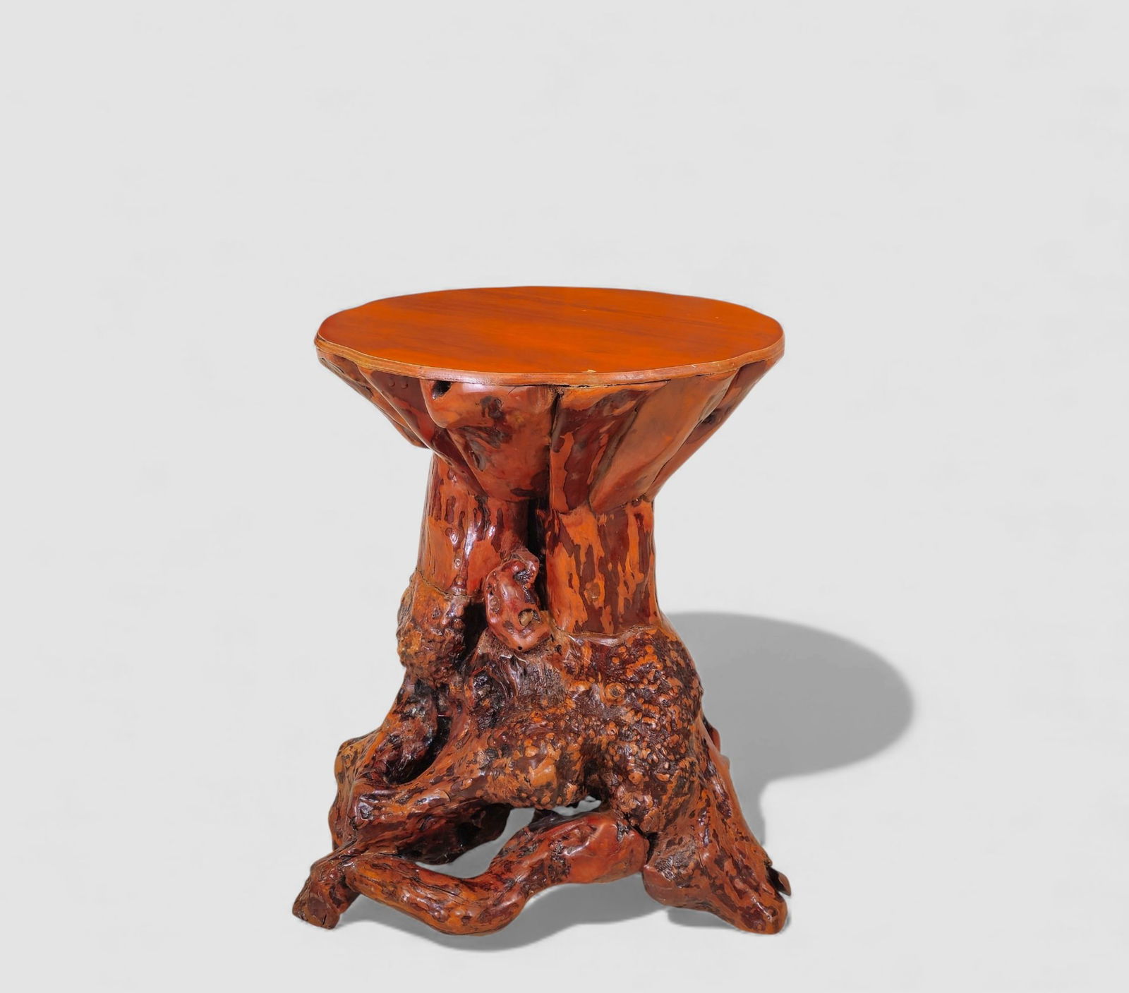 MCM Natural Root Carved Side Table: Natural wood side table crafted from a heavily knotted and organically contoured tree root base supporting a polished, free-form round top. The sculptural root structure features dramatic burls,