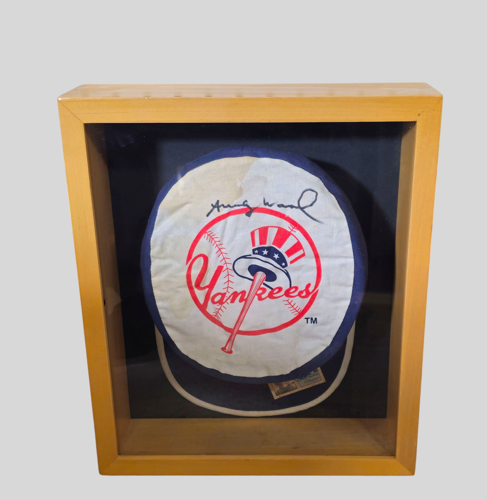 Andy Warhol Signed Yankee Hat: Andy Warhol (1928-1987) (Pa, NY) Andy Warhol Signed Yankee Hat in shadow box frame. Signed in marker upper center. Acid free mounting. Hat 7 1/2w x 2 3/4d x 10 3/8h.