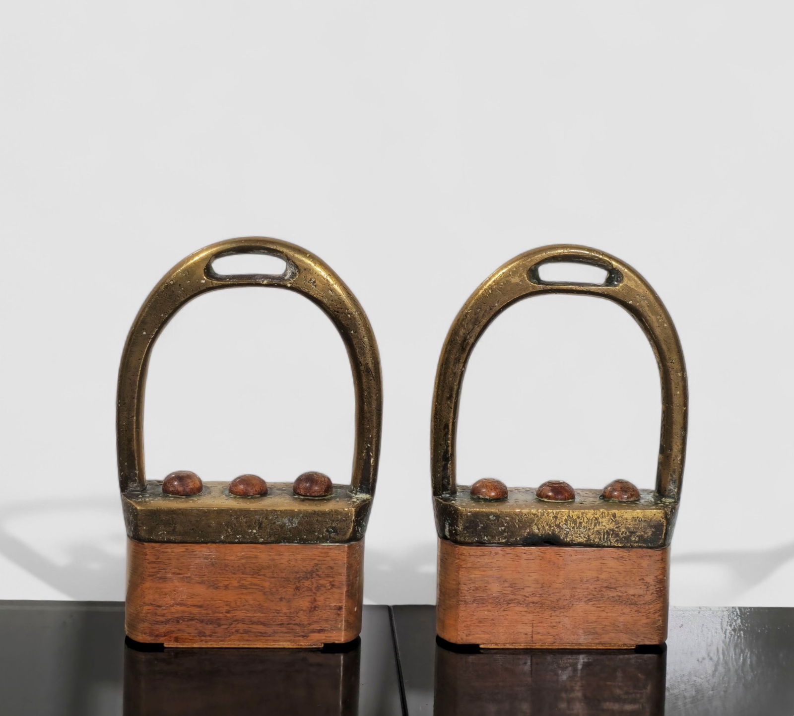 Brazilian MCM Brass and Wood Bookends: MCM Brass and Wood Bookends. Pair. Brazil. 1960. Cast brass and rosewood. 5w x 2 d x 8h.