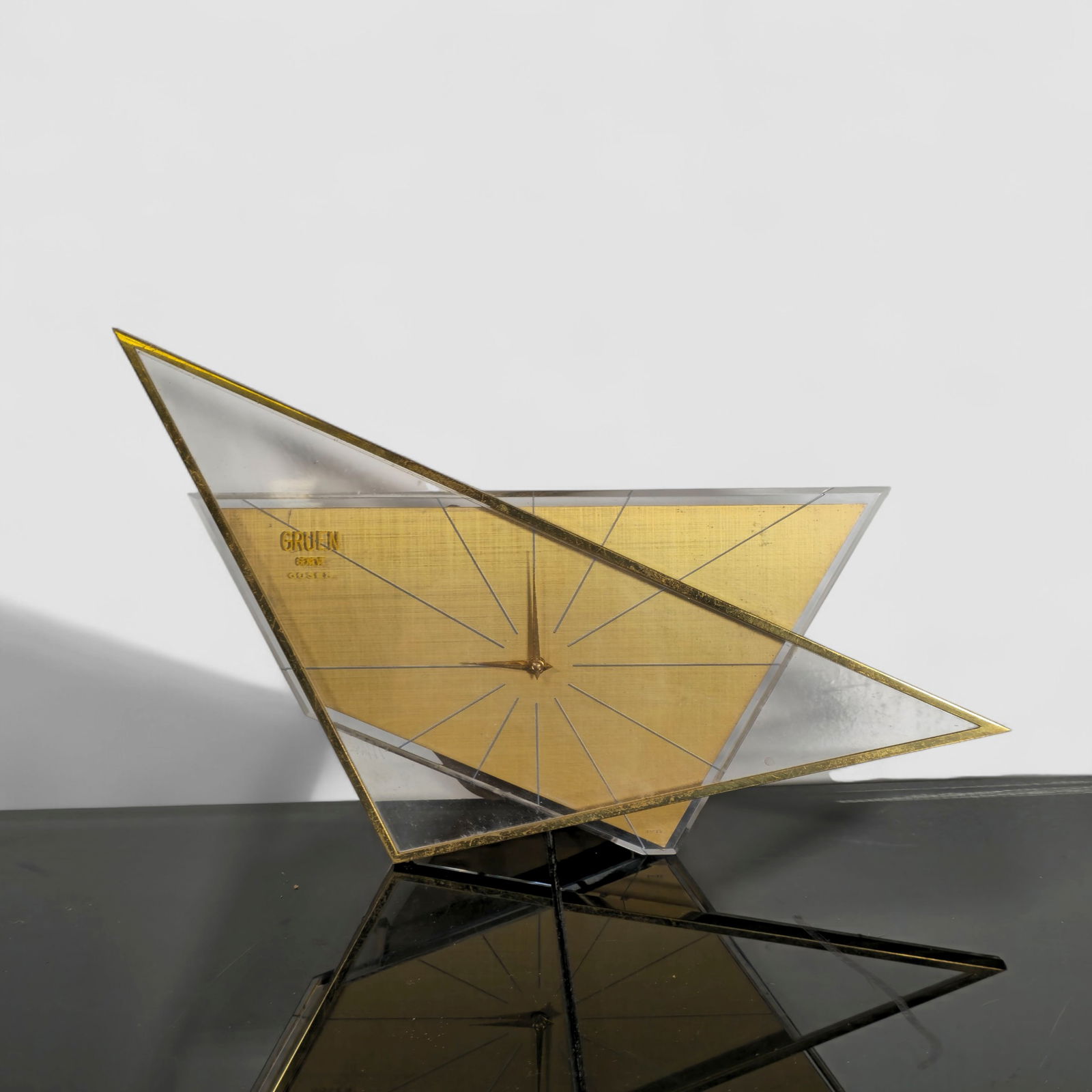 Rare Atomic Gruen Desk Clock: Rare Atomic Gruen Desk Clock. Gruen Geneve Gosen. USA. 1950. Glass, brass plated metal, gold leaf and chrome plated metal. 10w x 2 1/2d x 6 1/8h.