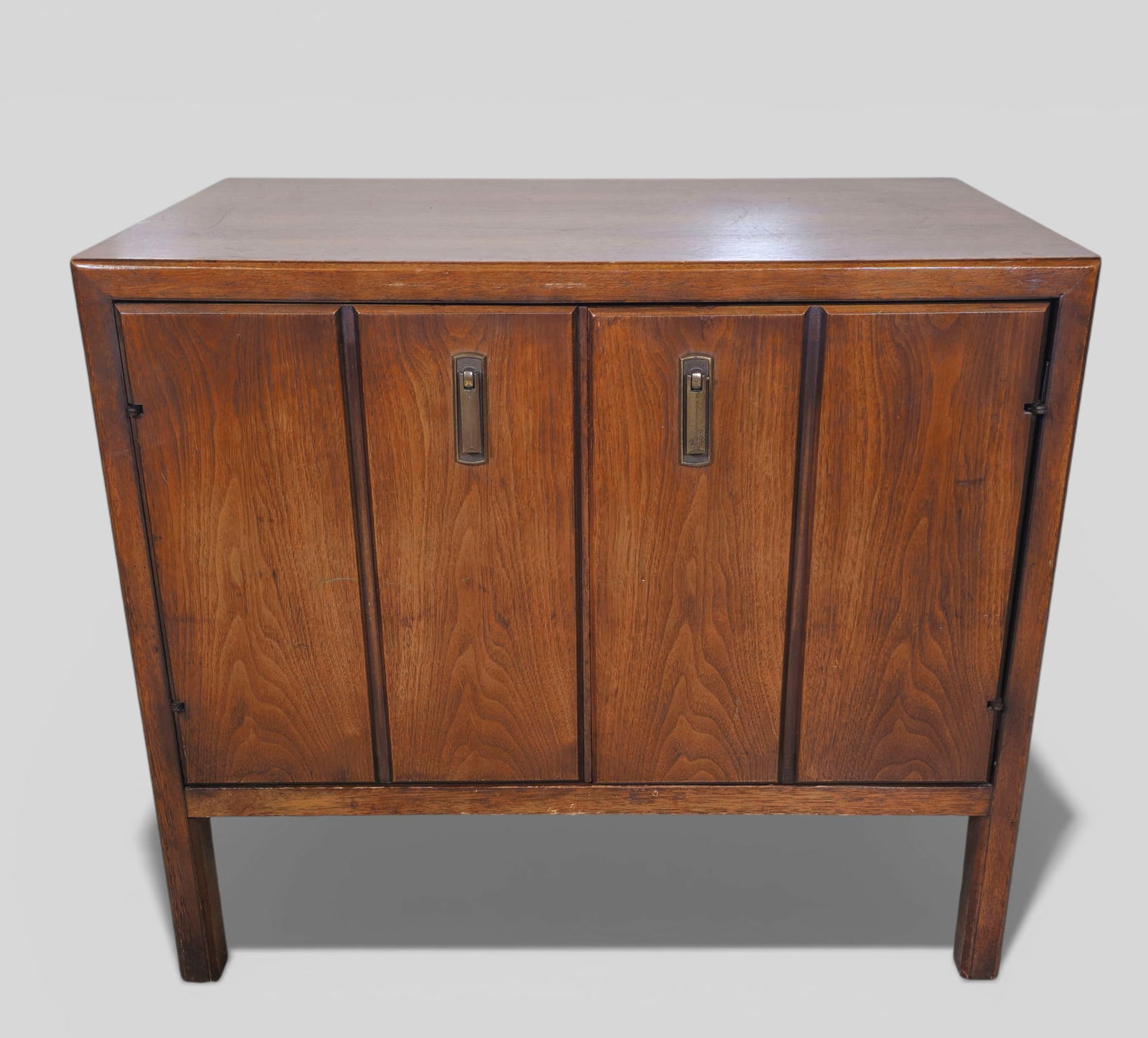 Broyhill MCM Cabinet/ Nightstand: Broyhill MCM Cabinet/ Nightstand. USA, 1960. Walnut and brass plated metal. 26w x 18d x 22h.