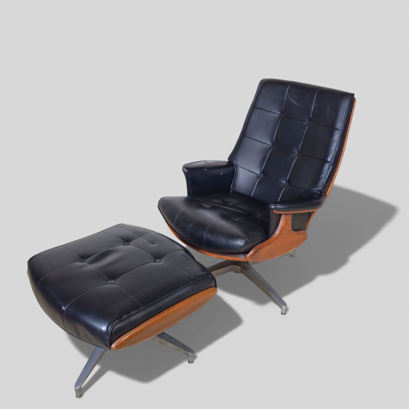 Heywood-Wakefield Chair and Ottoman: Heywood Wakefield swivel Loung chair and ottoman. USA. 1955. Stoned maple, aluminum and vinyl Chair- 39 3/4"h x 29 1/2"w x 32"d. Ottoman 16"h x 25" x 23 1/2"