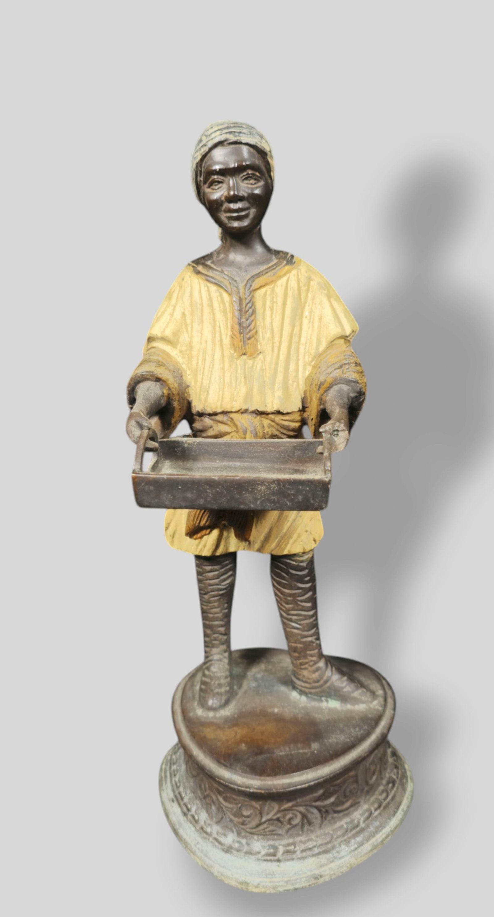 Cold Painted Bronze Figure Holding Tray: Cold Painted Bronze Figure Holding a Tray. 20th Century. Raised on free form base with high relief scrolling and fleur de lis. 4 1/4w x 4 1/4d x 11 1/4h.