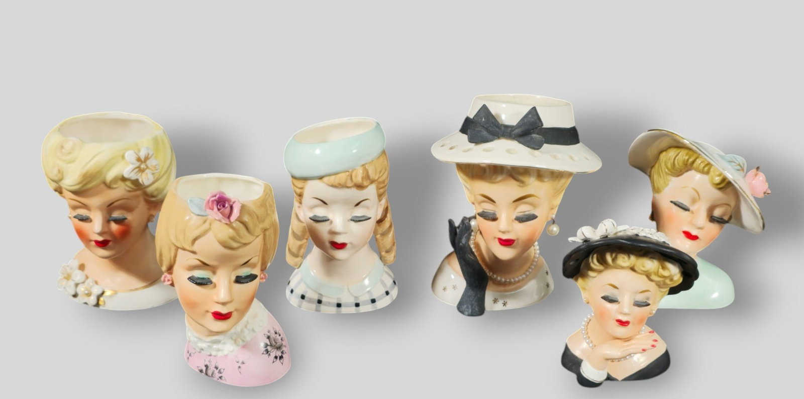 Assembled Inarco And Enesco Lady Head Vases: Assembled Inarco And Enesco Lady Head Vases. 6 total. 1950s/ 1960s. All with eyelashes. Various forms and sizes. Manufacturer's mark to underside of most. Largest 5w x 5d x 7 3/8h. Smallest 3 5/8w x
