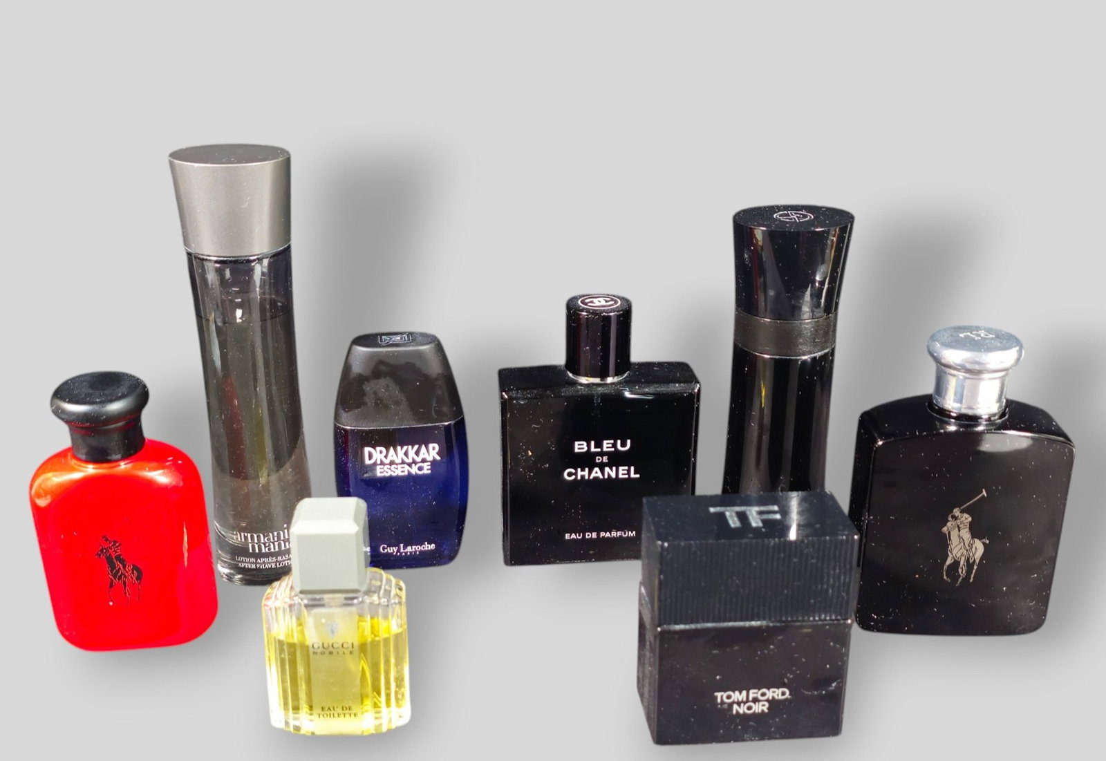 Assembled Cologne Collection: Assembled Cologne Collection. 8 bottle total. Black Polo, Red Polo, Gucci, Tom Ford, Drakkar, Bleu de Chanel, Armani Mania and Armani Code. Tallest Bottle 1 3/4dia x 7h.
