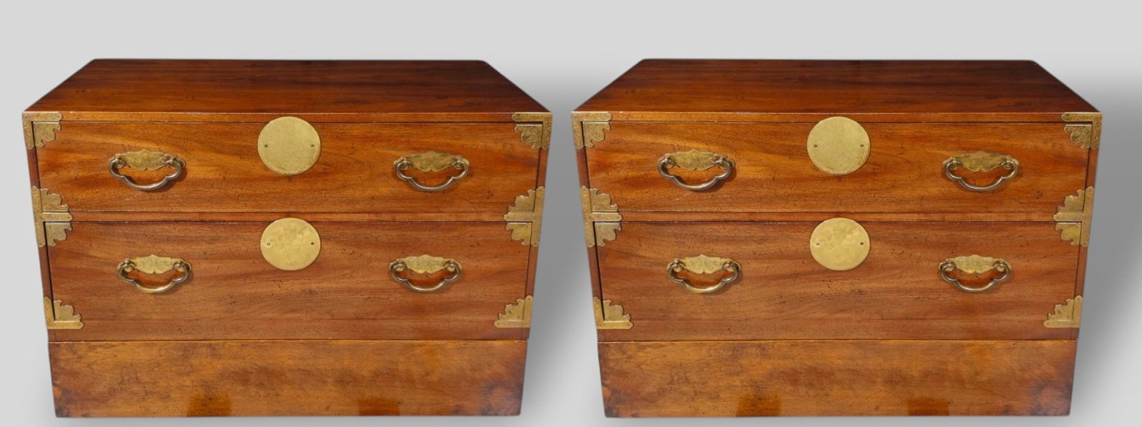 Henredon Tansu/Bedside Chest, Pair: Henredon Tansu/Bedside Chest, Pair. USA, 20th century. Two drawers to each with Asian motif pulls and mount. Each cabinet sits on one drawer base. Walnut and brass. Manufacturer's mark to drawer.