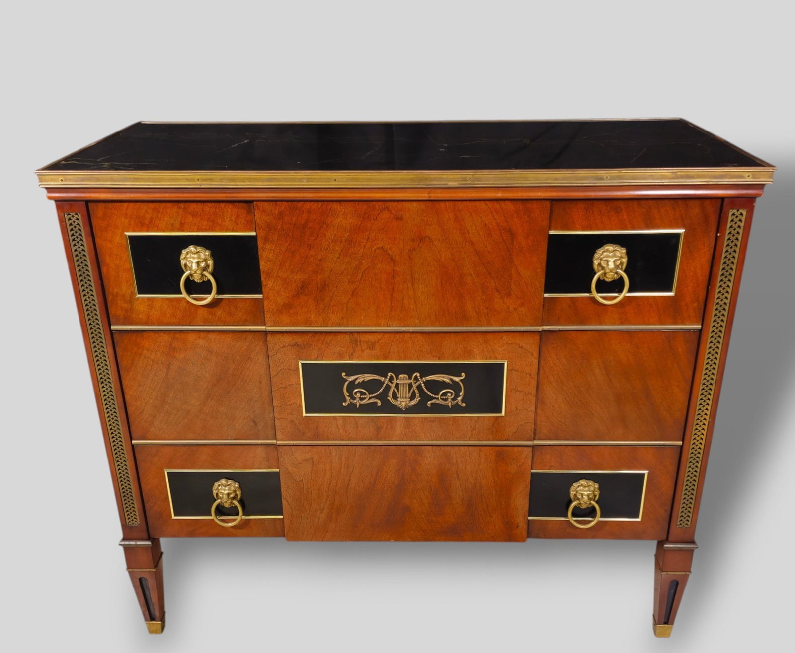 John Widdicomb Hollywood Regency Marble Top Commode / Chest / Dresser: John Widdicomb Hollywood Regency Marble Top Commode / Chest / Dresser. 20th Century. Marble top with brass trim over 3 drawers. Lion head mounts and ring oils over black lacquered panels. Brass trim