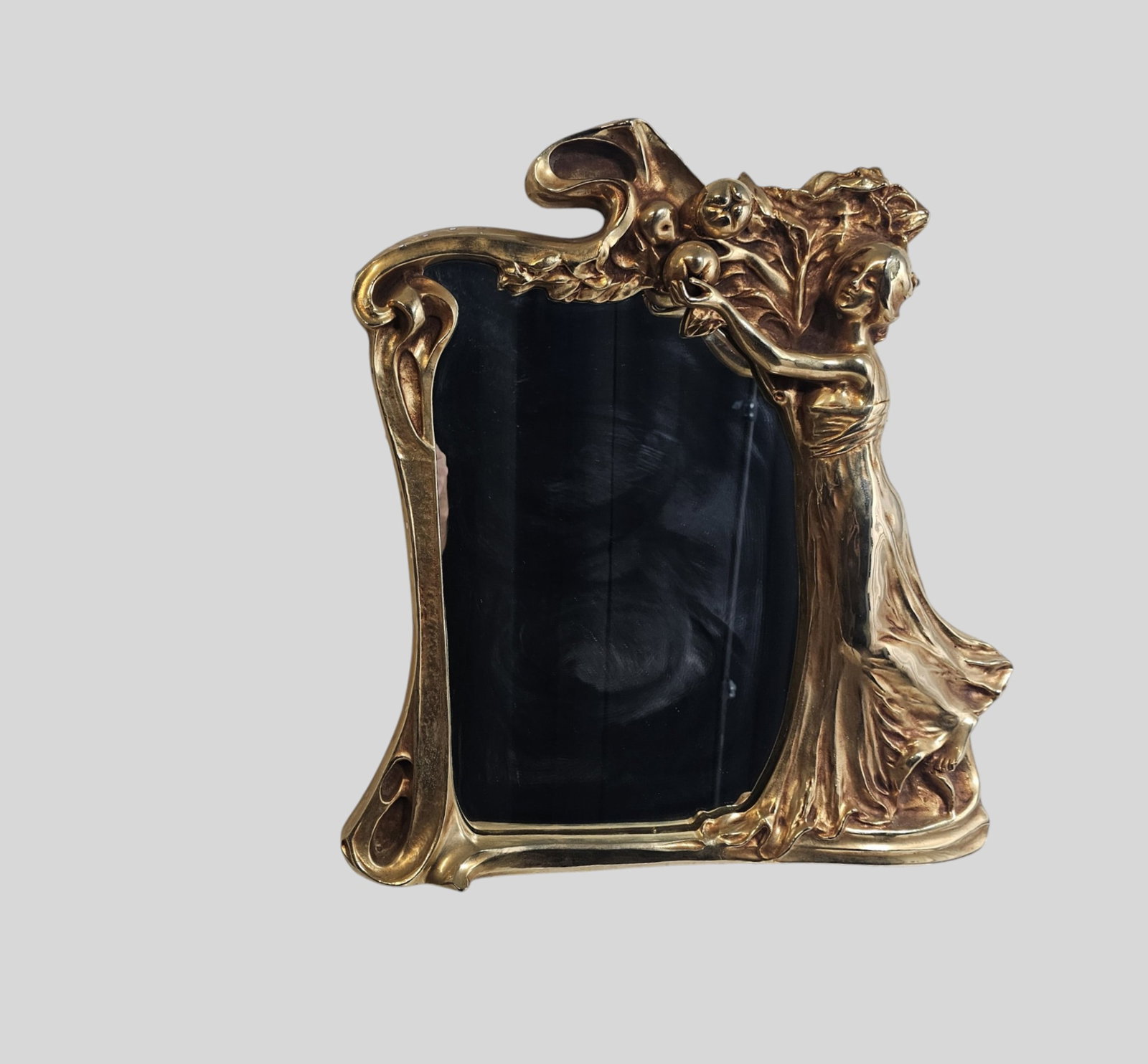 Art Nouvea Stle Gilt metal Mirror: Art Nouvea Stle Gilt metal Mirror. Cast metal gilt frame with high relief maiden picking fruit. 22w x 3d x 24h.