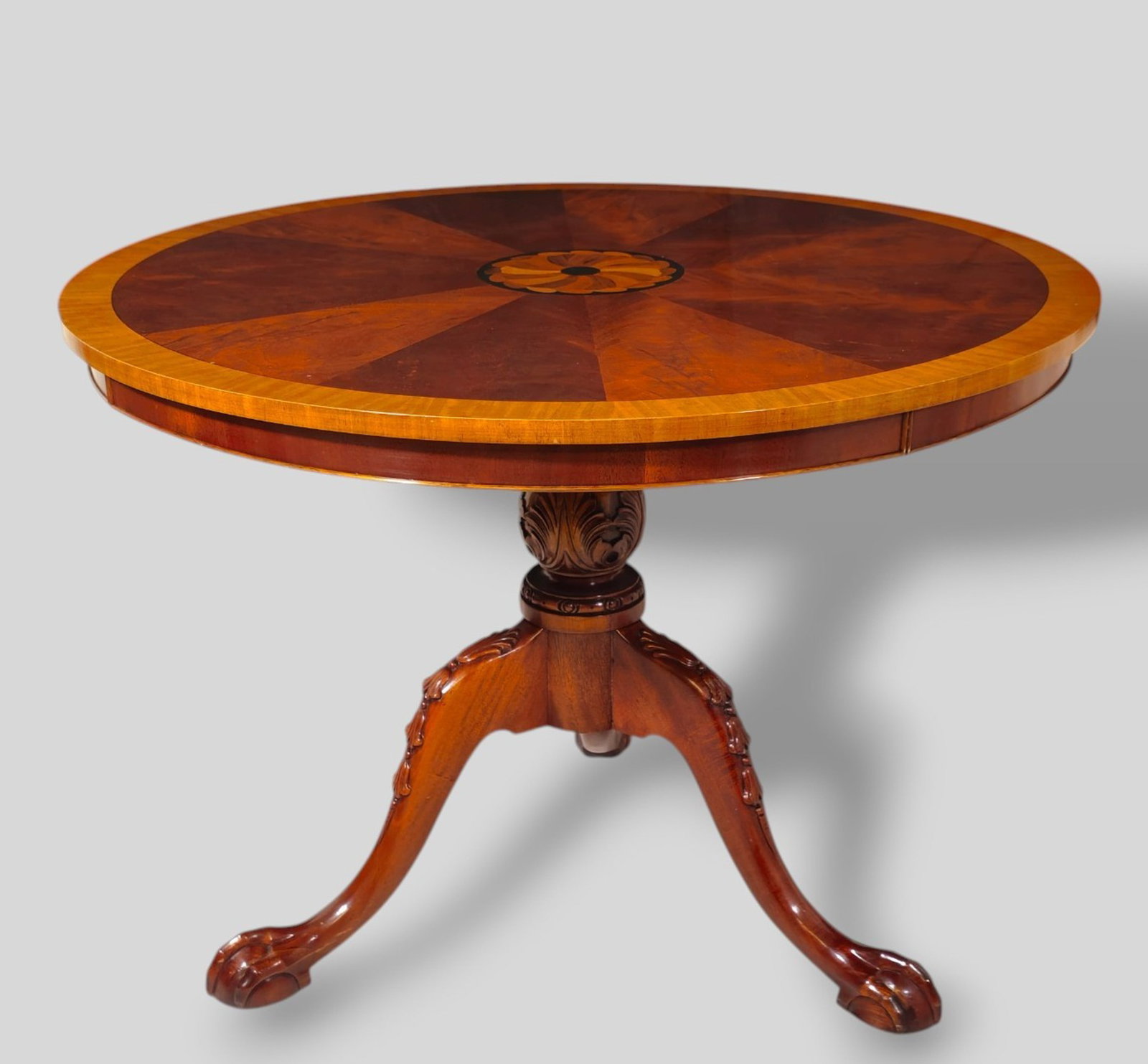 Chippendale Style Mahogany Inlaid Fourier Table: Chippendale Style Mahogany Inlaid Fourier Table. 20th Century. Mixed inlay top with center medallion and banded border. Carved ballasted support resting on cabriole legs. Large claw and ball feet. 40