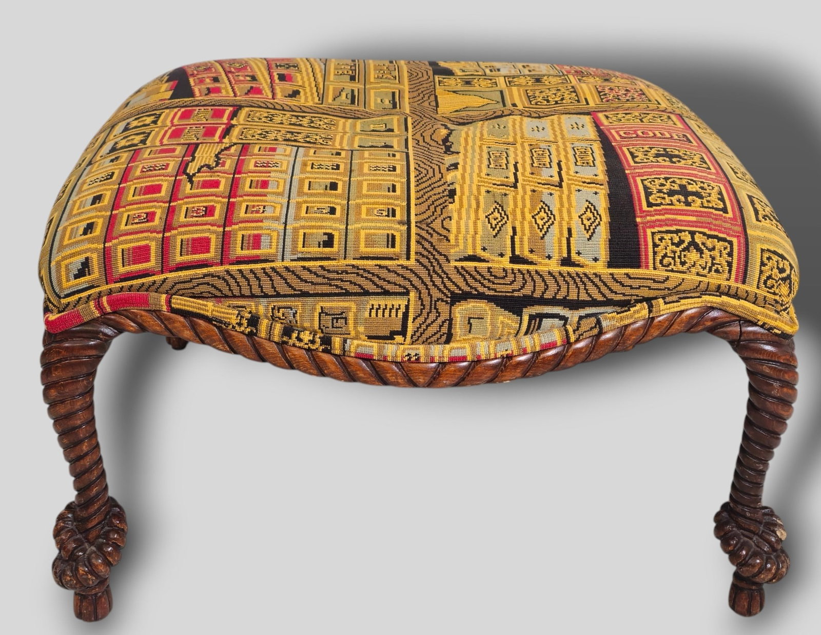 Braided Wood Rope Ottoman: Braided Wood Rope Ottoman. 20th Century. Book print needlepoint upholstery. Ottoman has rope tied and tassel feet. 27w x 27d x 17h.