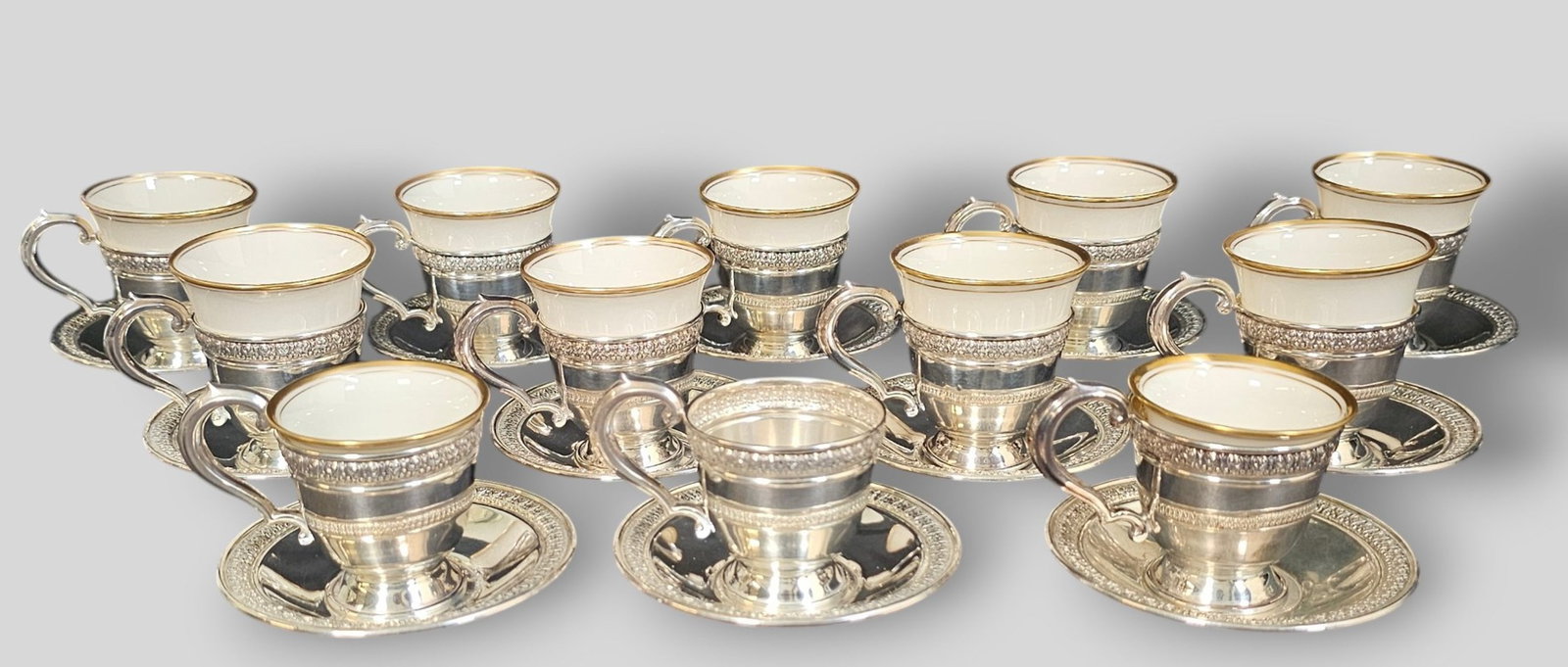 Sterling Silver Demitasse Cups and Saucers Lenox Liners: Sterling Silver Demitasse Cups and Saucers Lenox Liners. 12 sterling cups and saucers but only 11 liners. Marked sterling. 3 1/2 dia x 2 1/2h. Weight 22.74 ozt.