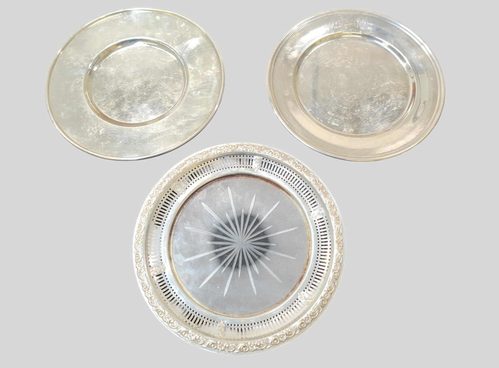 Assembled Sterling Silver Butter Plates and Dish: Assembled Sterling Silver Butter Plates and Dish. Two odd sterling butter plates 6 1/8 diameter and a glass dish with pierced and floral border. 6 1/8dia. Weight of butter plates 7.575 ozt