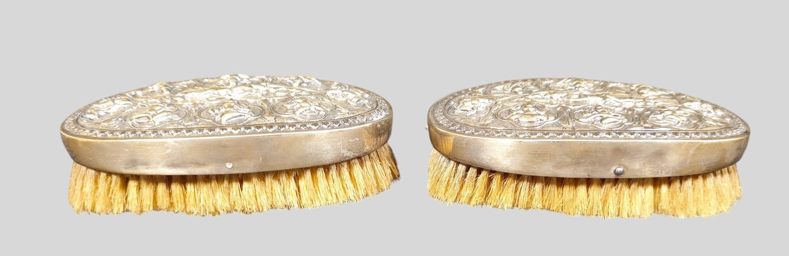Rare Sterling Silver Repousse Guanyin Brushes: Rare Sterling Silver Repousse Guanyin Brushes. Pair All over Guanyin design with gadroon border. Tested. 51/8w x 31/8d x 2 3/4h.